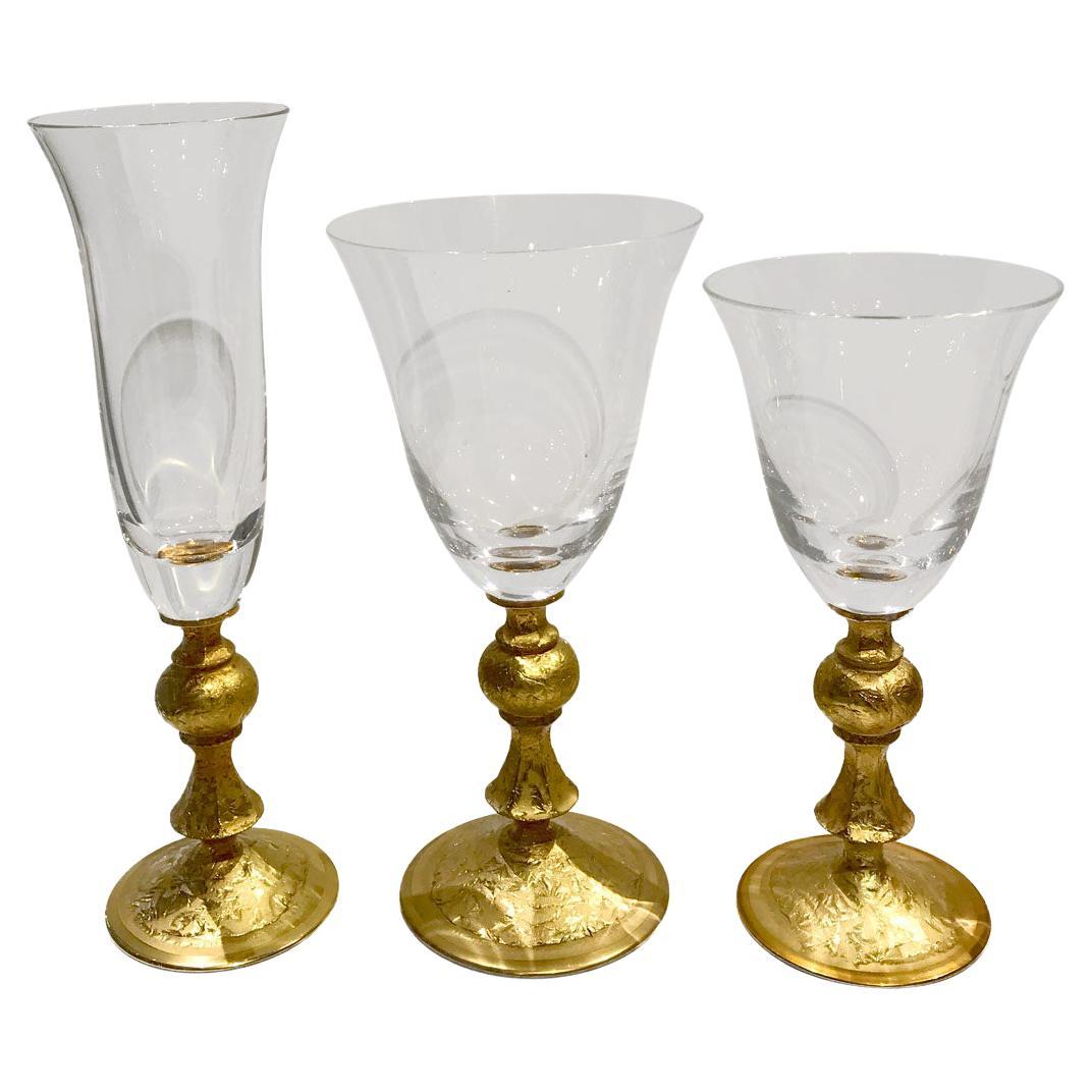 Exquisite set of 20 glasses composed of 5 types of glasses made from solid glass and with a large golden rim with wonderful engraved abstract adornments. This set reflects the timeless excellence of Italian craftsmanship and will enrich the look of
