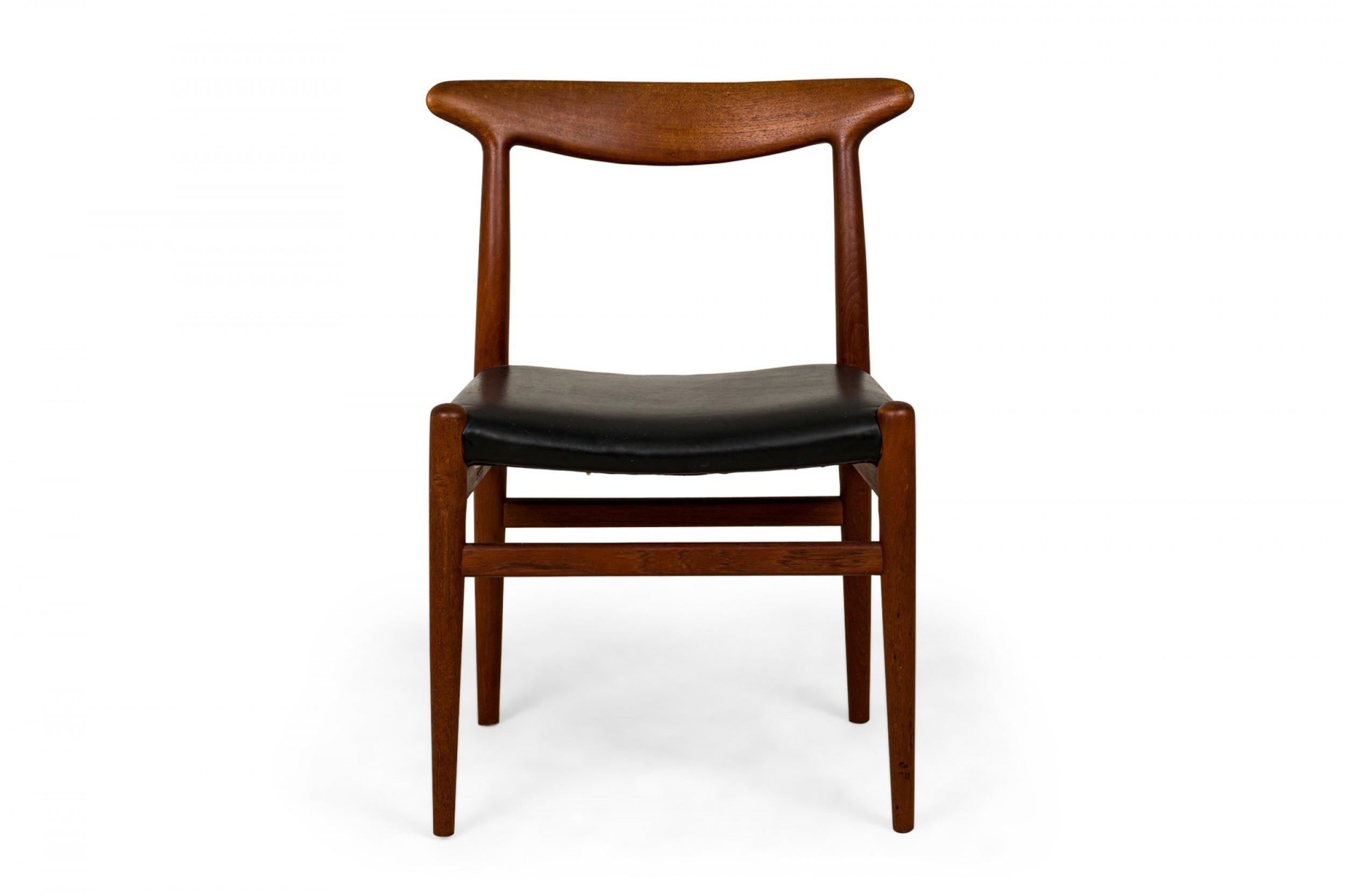 SET of 5 Danish Mid-Century dining side chairs with shaped teak wood frames and black leather upholstered seats, resting on tapered dowel legs with stretchers. (HANS WEGNER FOR C.M. MADSEN)(PRICED AS SET)
