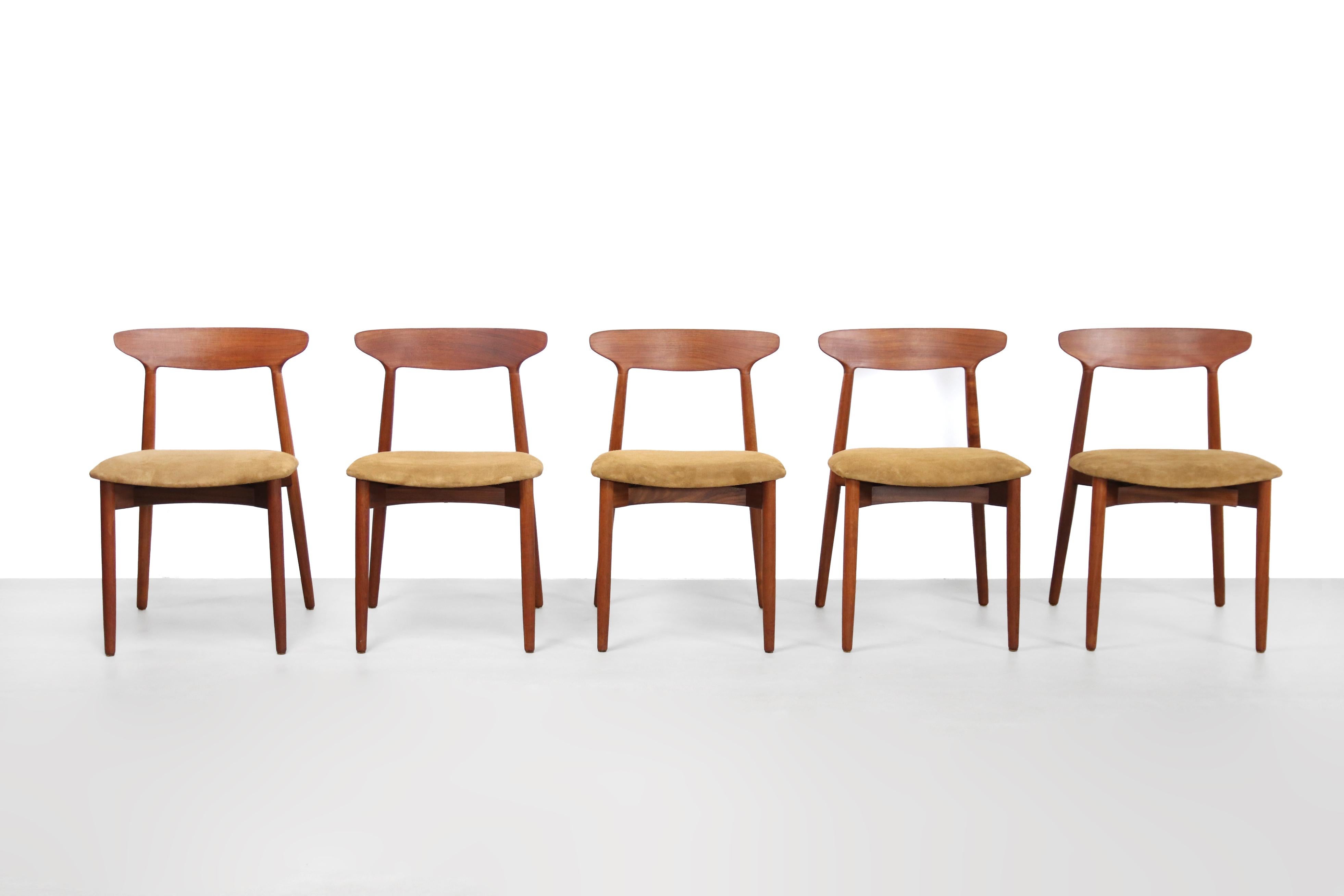 Nice set of five Danish designer: Harry Ostergaard dining chairs produced by Randers Mobelfabrik in Denmark in the late 1950s. These uncommon chairs are made of solid teak wood with beautiful traditional wood connections. These chairs are of high