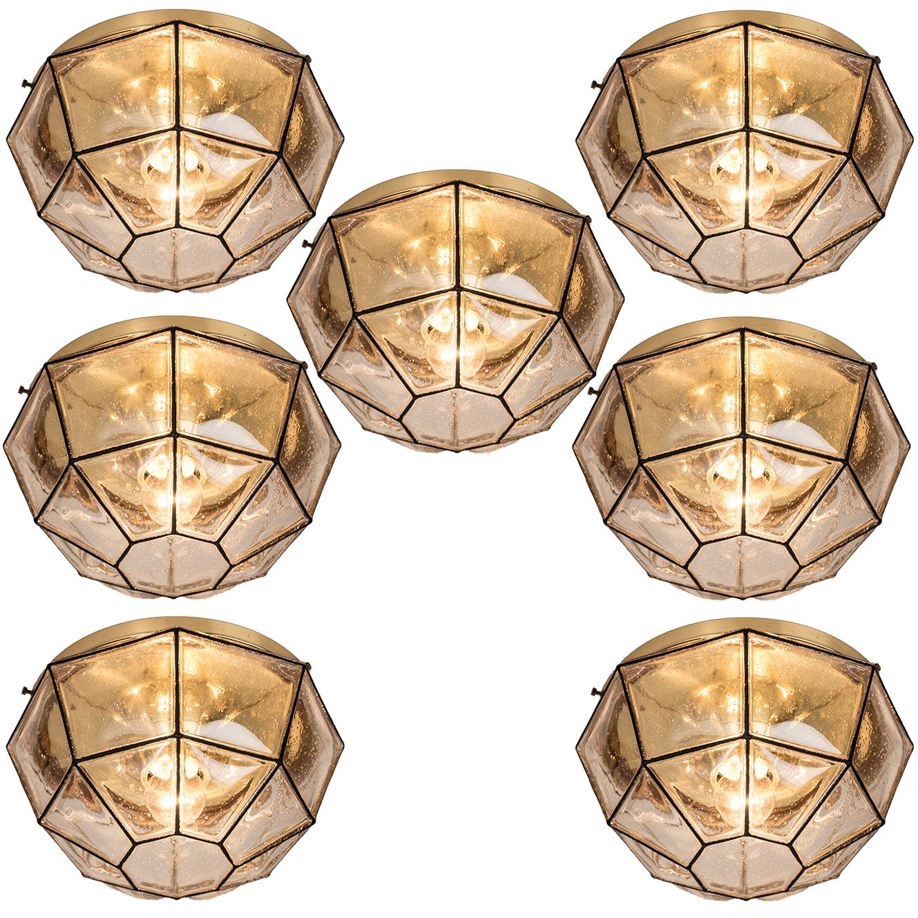 This beautiful and unique octagonal set of glass light flush mounts or wall lights were manufactured by Glashütte Limburg in Germany during the 1960s (late 1960s or early 1970s). Nice craftsmanship. Elaborate clear bubble glass which bulges slightly