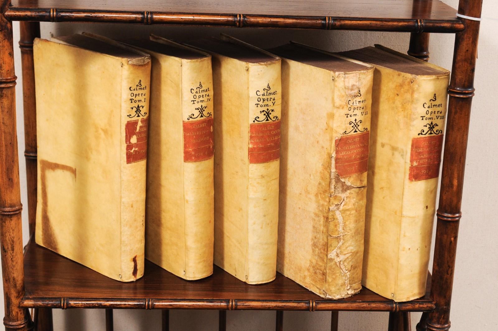 A handsome collection of 5 Italian 18th century vellum bound books. This set of religious books from Italy, which retain their original vellum bindings, are dated from 1734 to 1735. The books seated side-by-side measure as an approximate 13