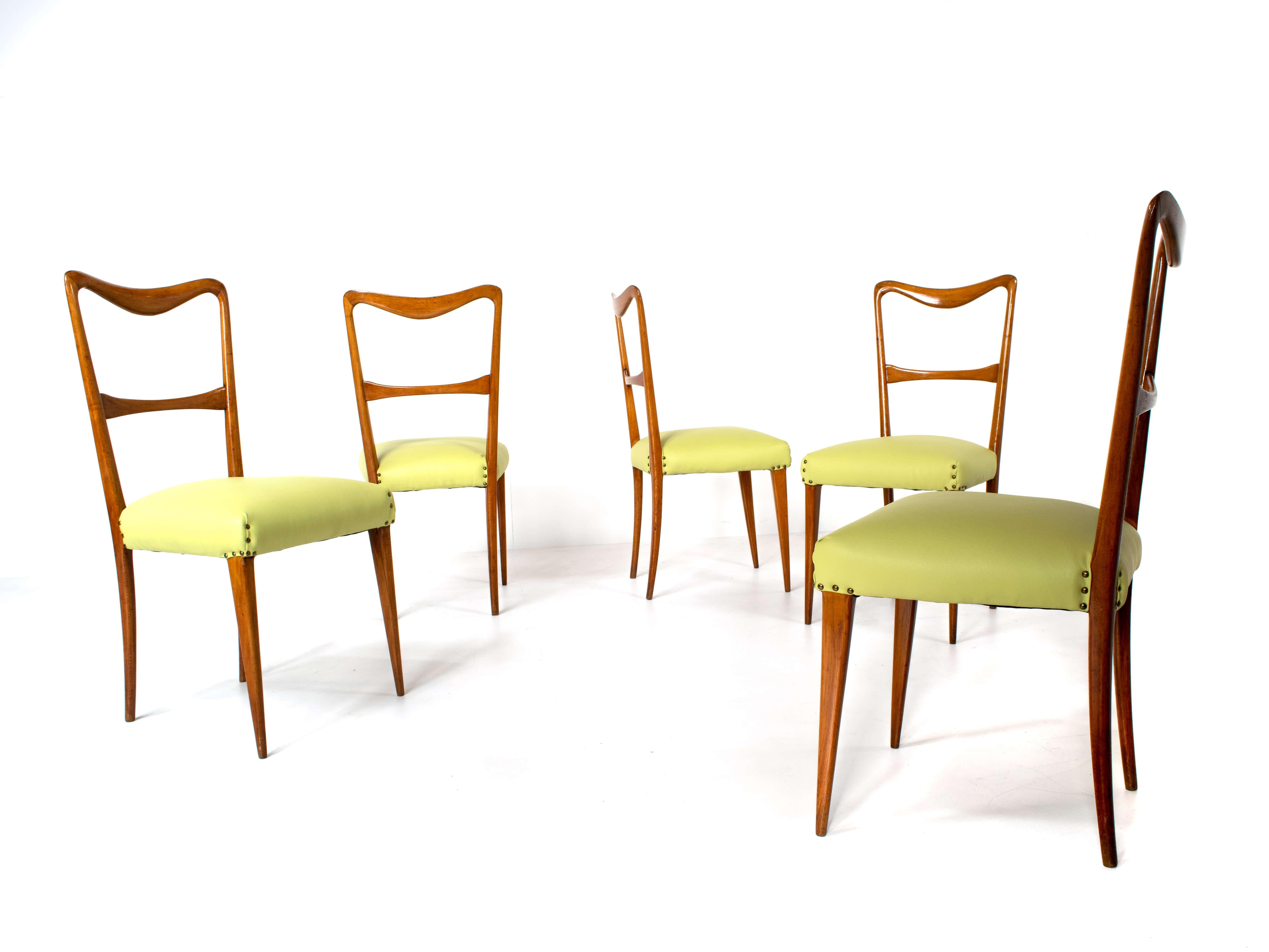 Set of 5 Italian modern dining chairs in style of Paolo Buffa from the 1950s. These chairs have a very elegant back with round curves. The chairs are newly upholstered with a green leather seating. They are light as a feather and easy to handle,