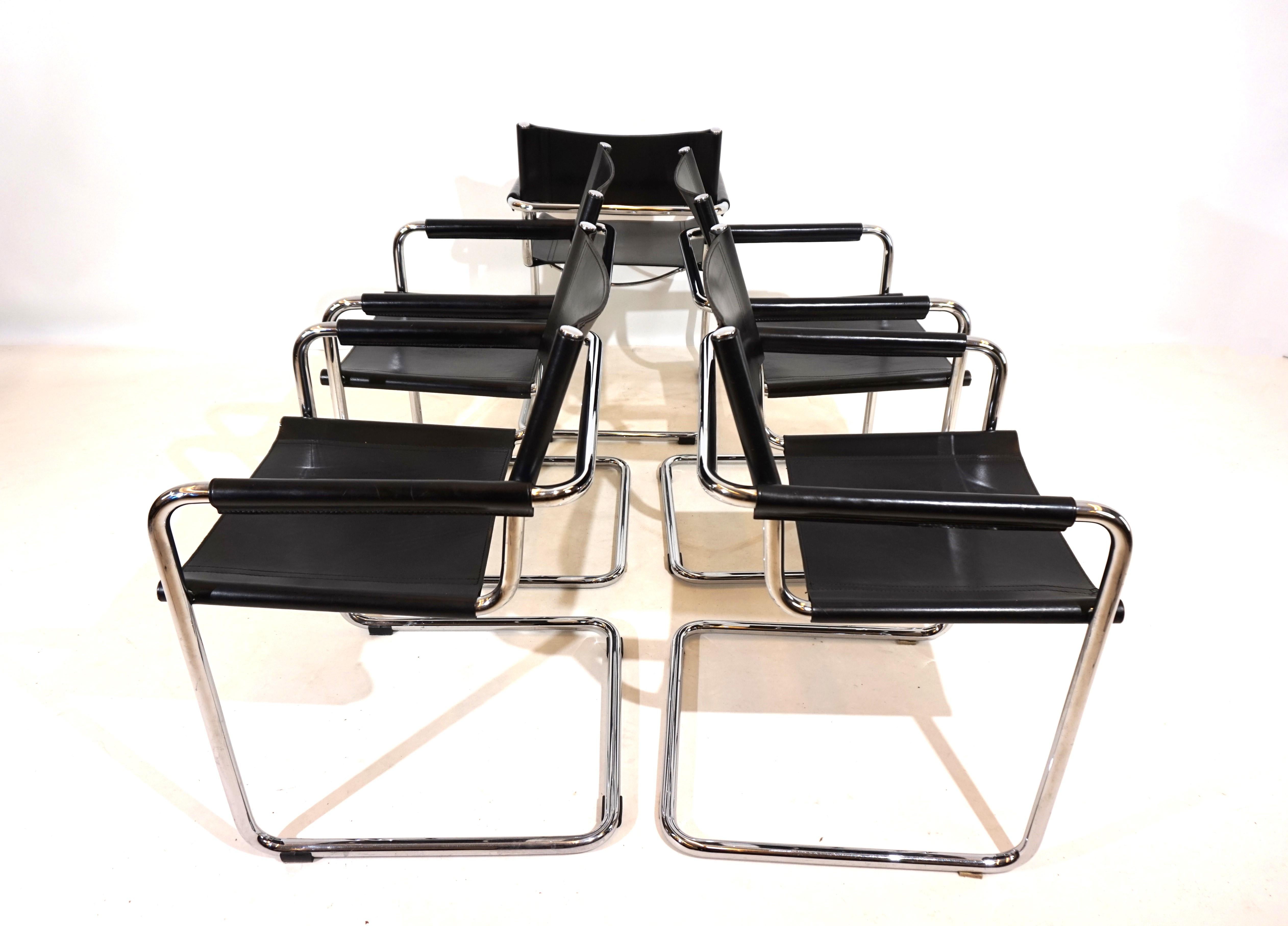 This classic cantilever set of 5 MG5 chairs in black saddle leather is in excellent condition. The thick leather shows minimal signs of wear, the chrome frames are in very good condition. The armrests are designed in the more exclusive