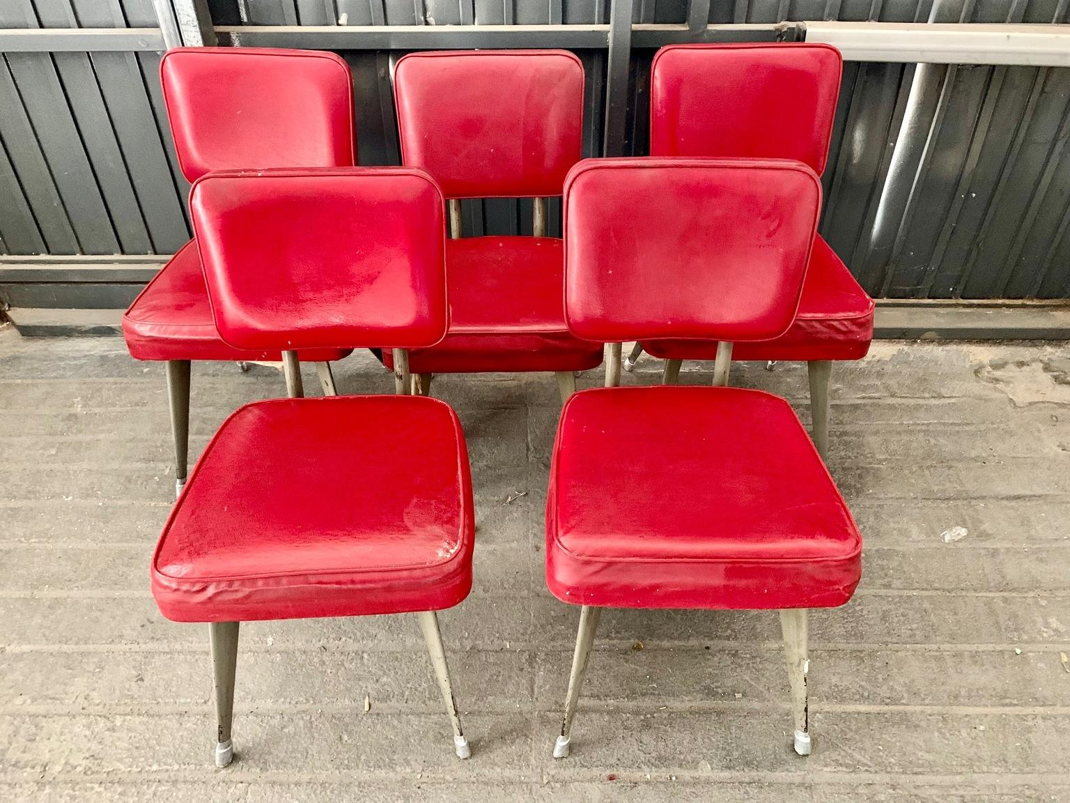Set of five chairs of Italian industrial design from the 1960s, chromed metal frame and upholstered in red faux leather.