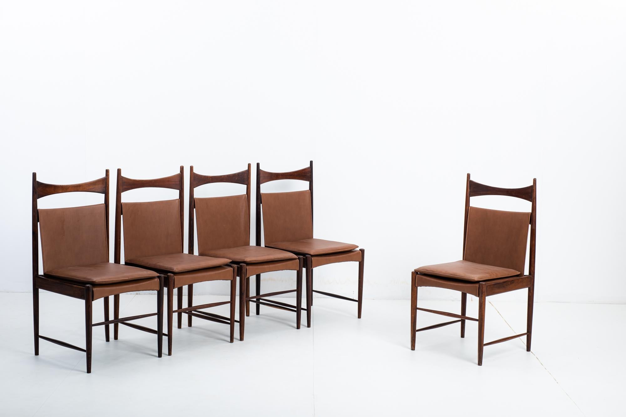 Set of 5 Cantu Alta chairs by Sergio Rodrigues, Brazil, 1960s.

Chairs made of solid wood, with natural leather upholstery.

The chairs are period originals, and underwent a slight restoration when we acquired them. The old varnish was removed, and