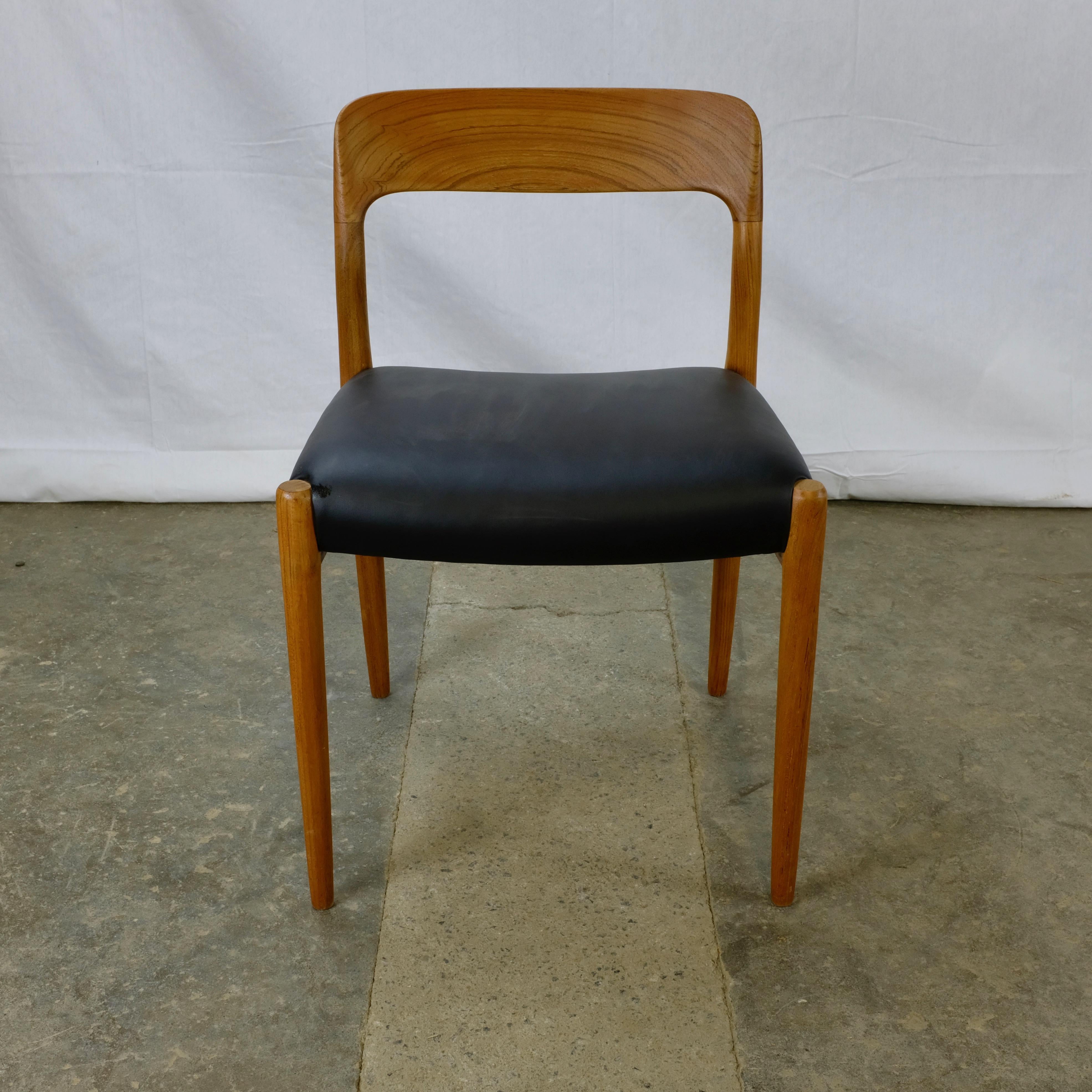 Set of five model 75 dining chairs designed by Niels Otto Møller and made in Denmark by J. L. Møllers Møbelfabrik. 

The frames are made of solid teak with broad, gracefully curved backrests, each carved from a single piece of teak. Four of the