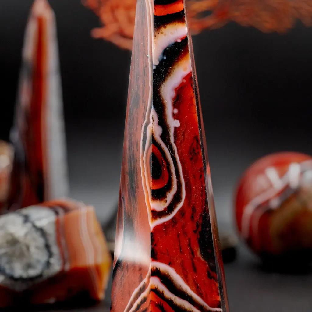 Elevate your interior spaces with this set of five Flower Agate obelisks — a natural stone with warm, intense tones ranging from deep red to luminous orange, delicately veined with white. Each obelisk is finely polished to reveal the stone’s natural