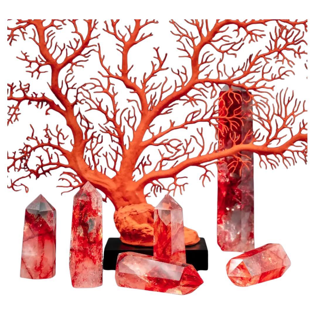 This set of five red quartz obelisks immediately captivates the eye with the intensity of their color and the luminous purity of the stone. Each crystal was originally a transparent quartz, known for its exceptional clarity and subtle ability to