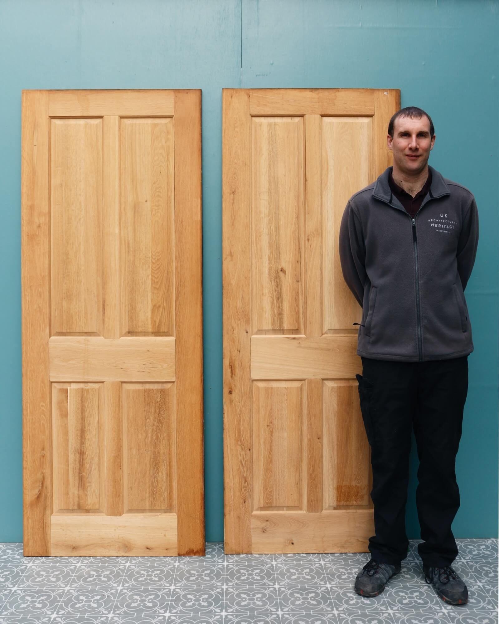 A set of 5 reclaimed 4-panel oak interior doors dating from the early 21st century. Perfect for a restoration project, these 5 doors are made from solid oak with a bare wood finish. They each feature 4 raised and fielded panels to the front and