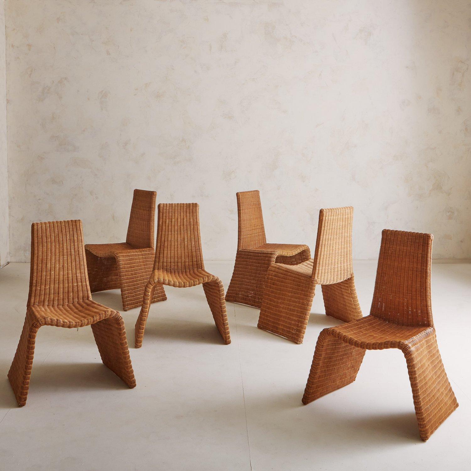 A set of 5 wicker dining chairs featuring sculptural frames with angled legs which connect seamlessly to the seat. We love the dramatic proportions on these statement chairs sourced in Spain, 20th Century.

6 chairs are pictured in the photos; we
