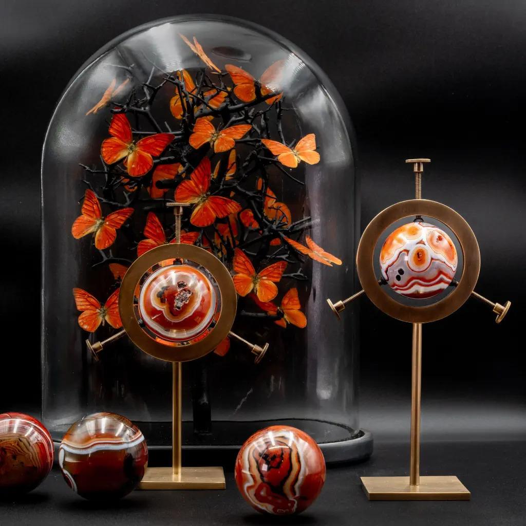 A distinguished member of the great chalcedony family, Sardonyx Agate captivates with its perfectly regular natural bands, alternating deep reds, milky whites, and intense blacks. These mesmerizing layers, born in the heart of volcanic rock, form a