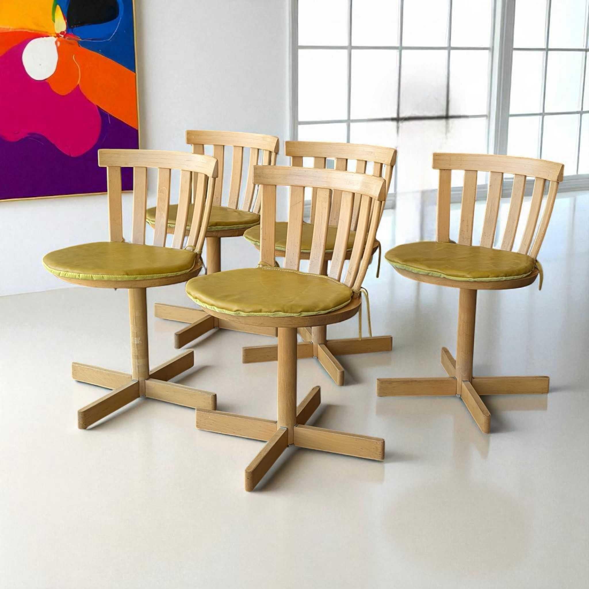 A rare and collectible set of five Mid-Century swivel chairs designed by Jan Hallberg and Sune Formell for Edsbyverken, Sweden, in 1967. These sculptural chairs are crafted from solid birch and birch veneer, featuring a curved slat backrest,