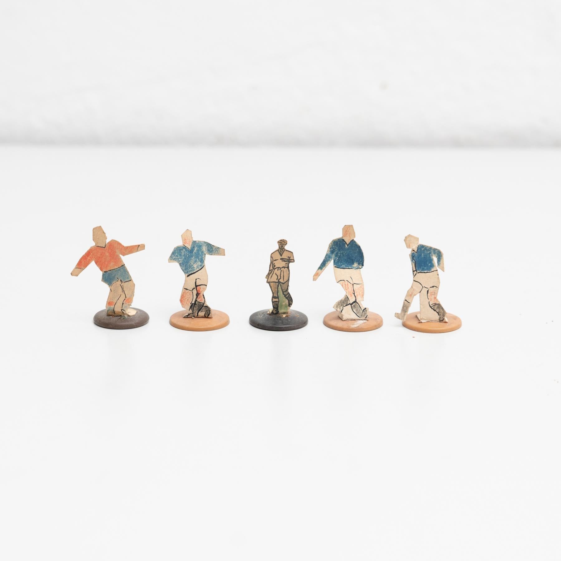 Set of five table button soccer game players. Traditional figures used to play this classic button Spanish game.     The players are build buy attaching a printed photography or drawing of an actual football soccer player to a clothing button.    