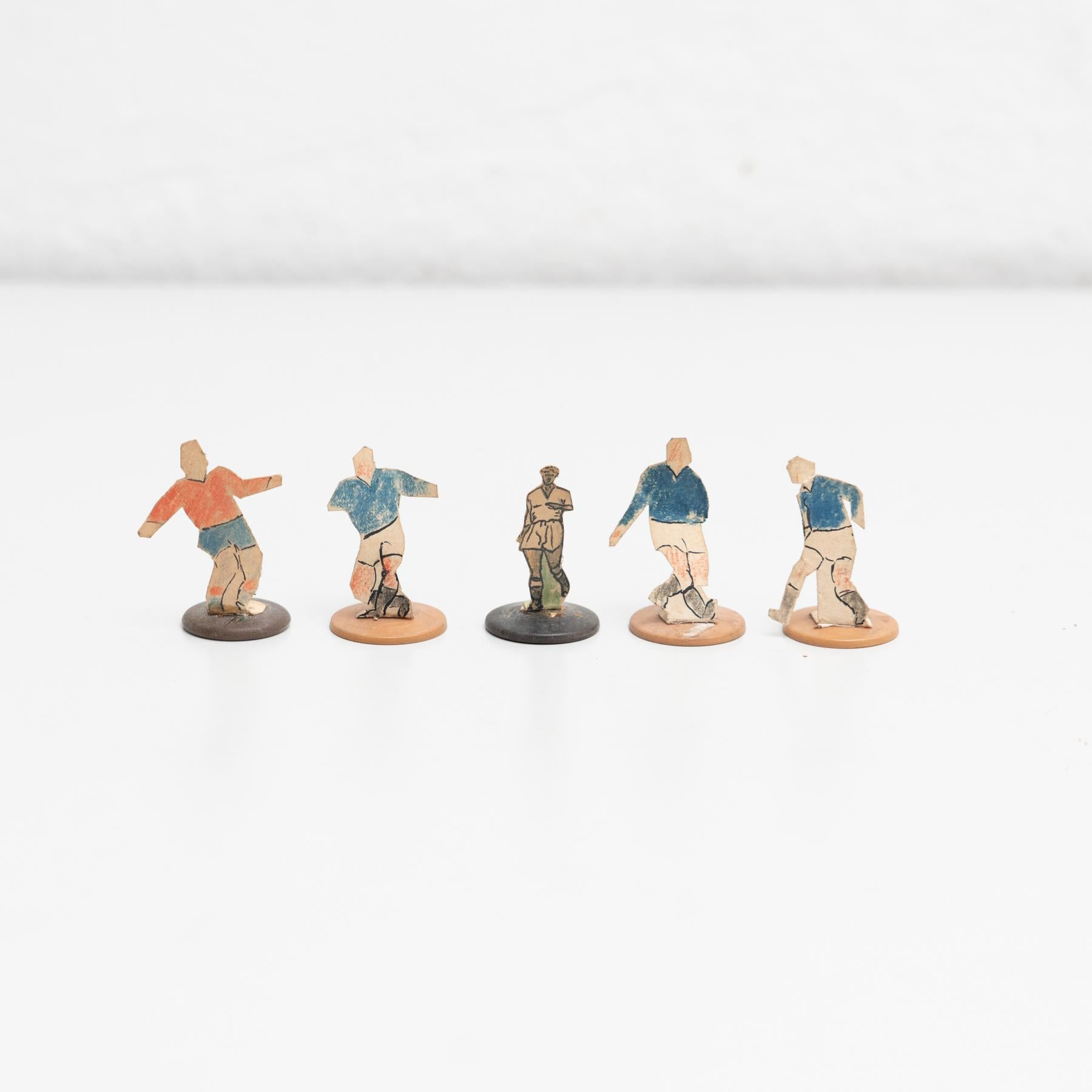 Set of five table button soccer game players. Traditional figures used to play this classic button Spanish game. 

The players are build buy attaching a printed photography or drawing of an actual football soccer player to a clothing button.