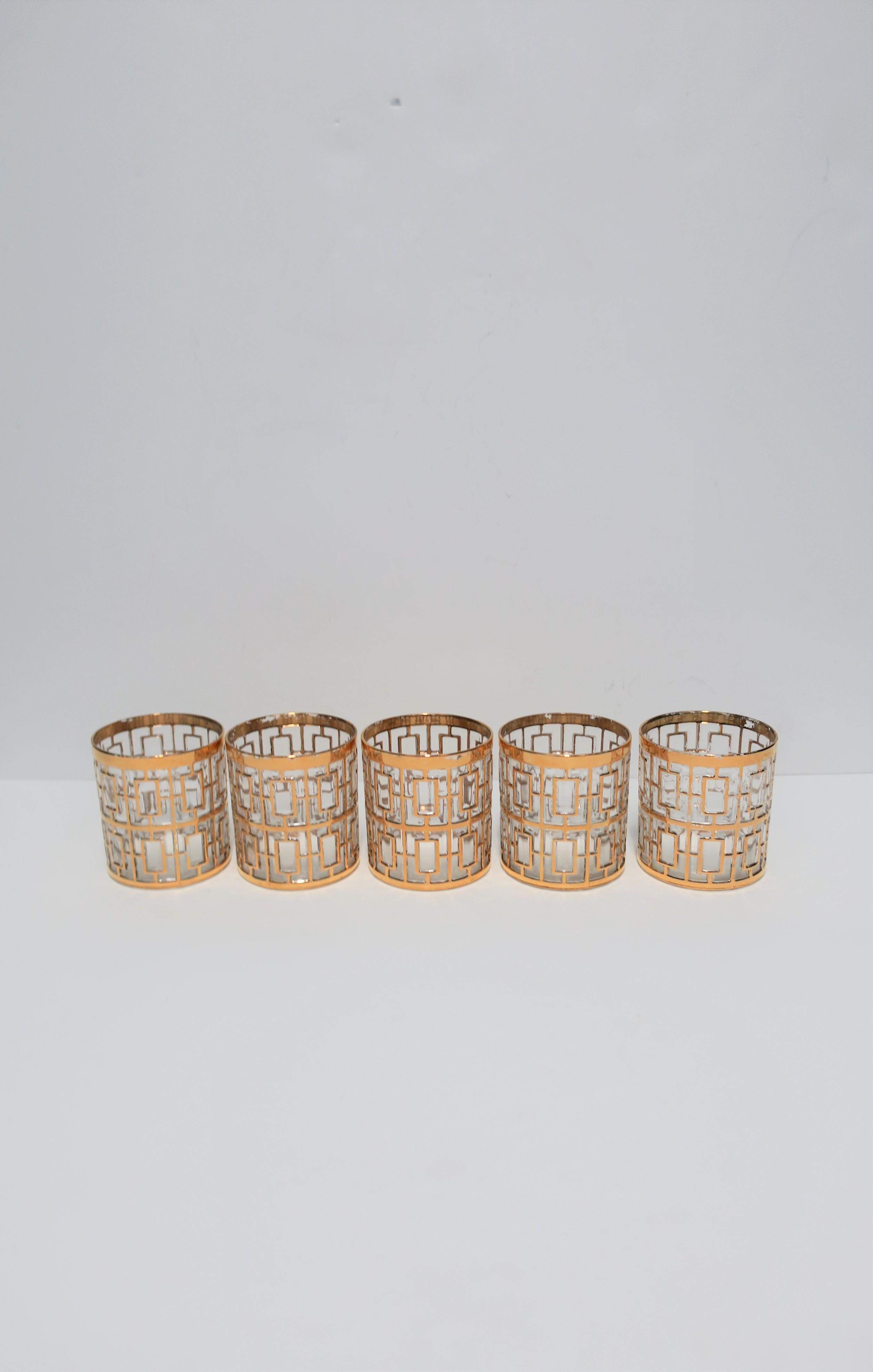 A beautiful vintage set of five (5) low-ball rock's glass in the Hollywood Regency style, circa 1960s. Glasses have a 22-karat gold-plate overlay on clear glass in the 'Shoji' screen pattern, which was signature to the maker, Imperial Glass. With