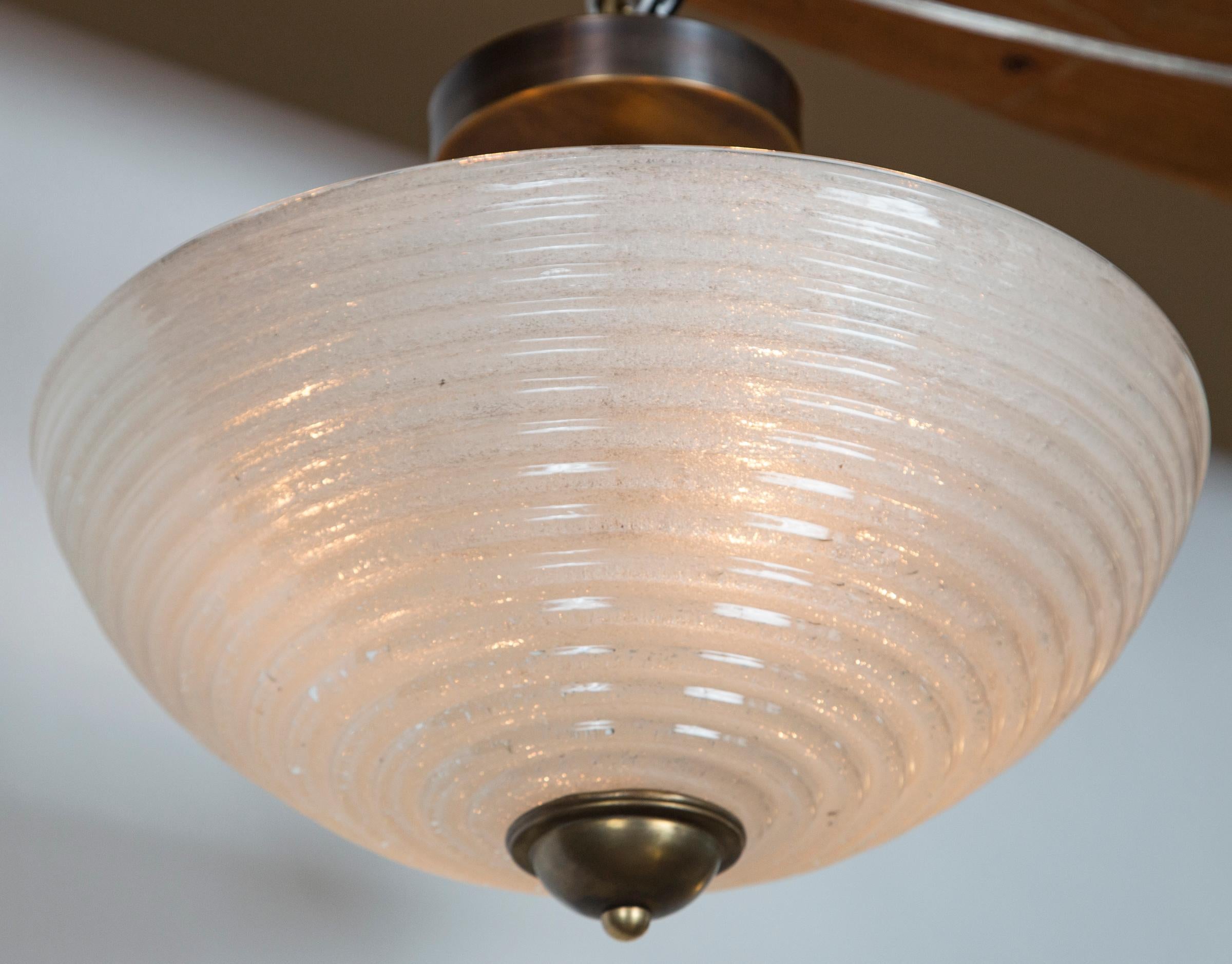 A set of four vintage ribbed dome-shaped ceiling fixtures blown in the pulegoso technique (glass formed with tiny bubbles)which creates an incredible illumination quality, blown in an opaque white color.
sold as electrified to code with custom made