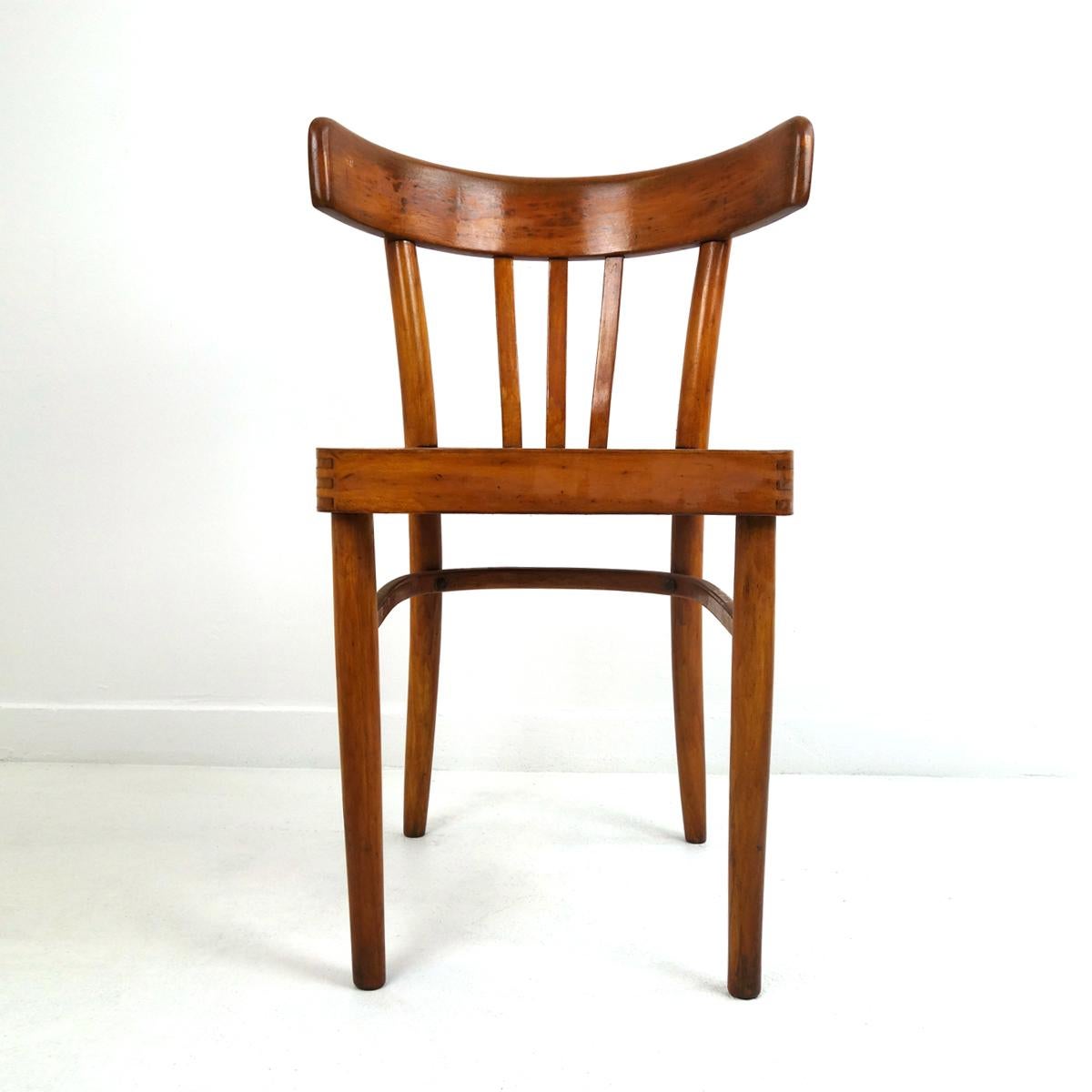 These five basic yet stylish dining chairs are from the brand KOK. 
The chairs are of simple and efficient design. The backrests made of bent wood are remarkably comfortable.
They are sturdy and solid and they have a nice patina. 
Numbered and