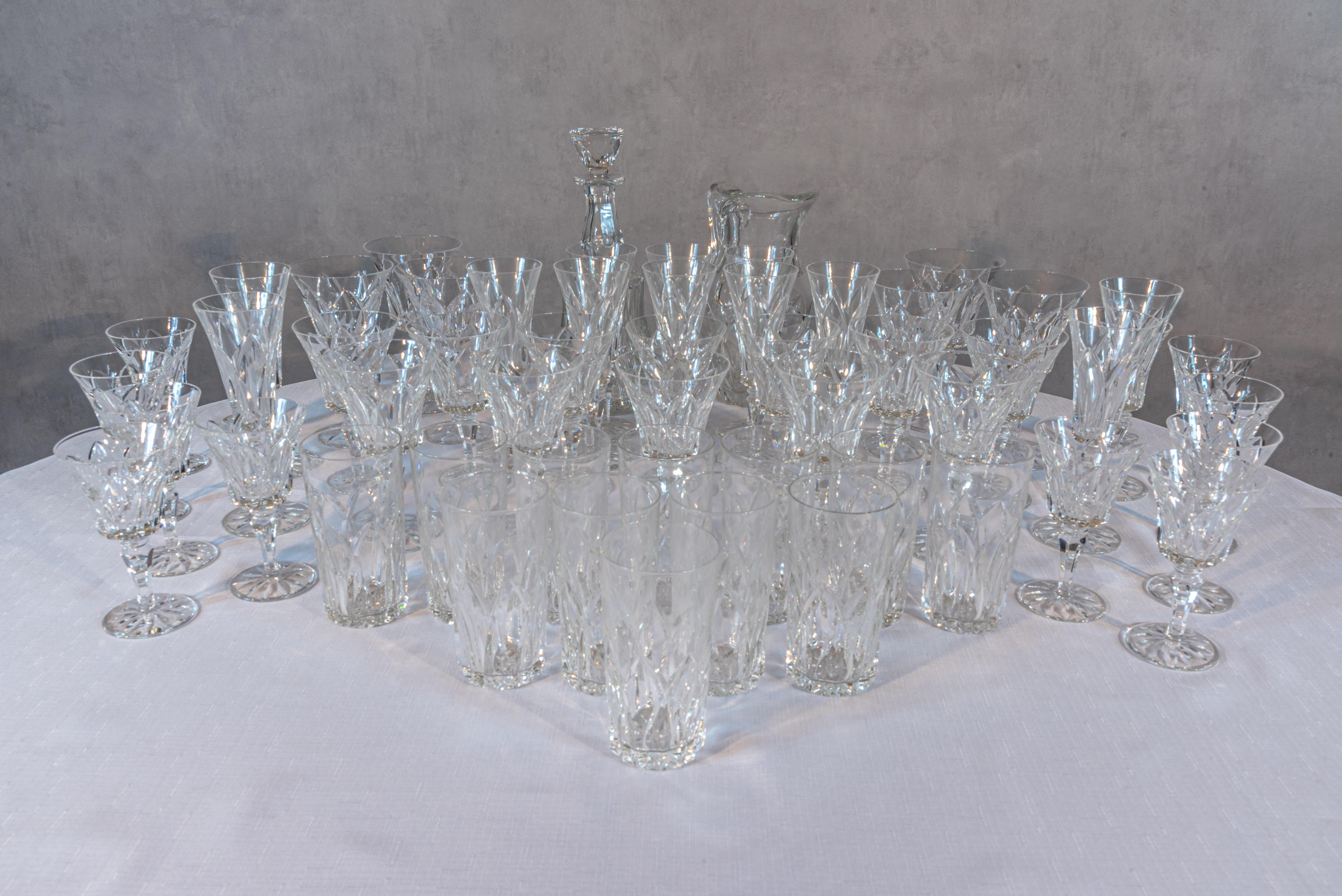 This Set of 55 Saint Louis Crystal is a luxurious ensemble that epitomizes refinement and elegance. Each piece is a testament to the exceptional craftsmanship and artistry of Saint Louis Crystal. The set includes a decanter, water carafe, flat water