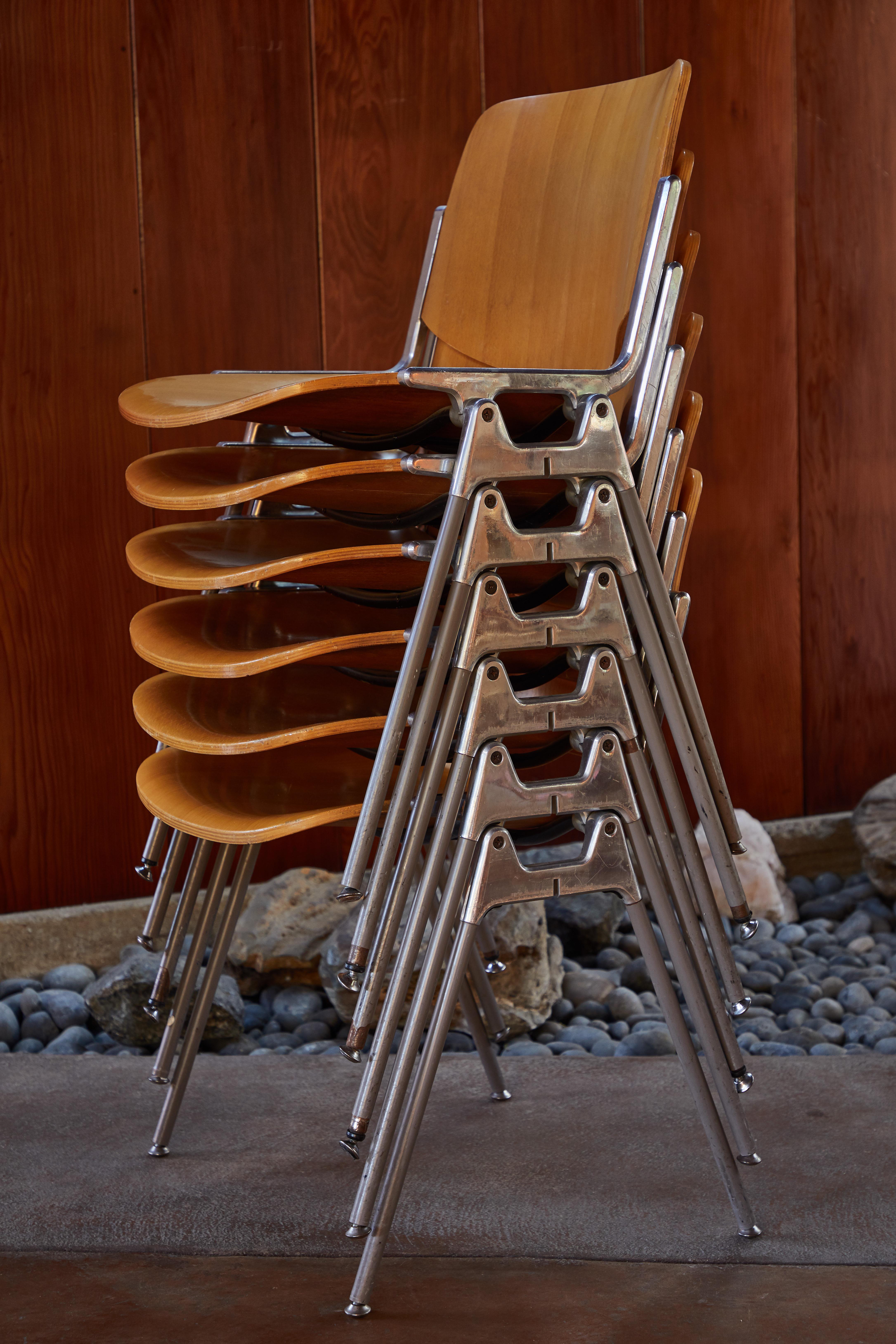 1960s Giancarlo Piretti Stackable chairs for Castelli. Executed in polished aluminum and wood. A quintessentially 1960s Italian design showcasing the highest level of refinement, materials and craftsmanship.

Price is for the set of 6