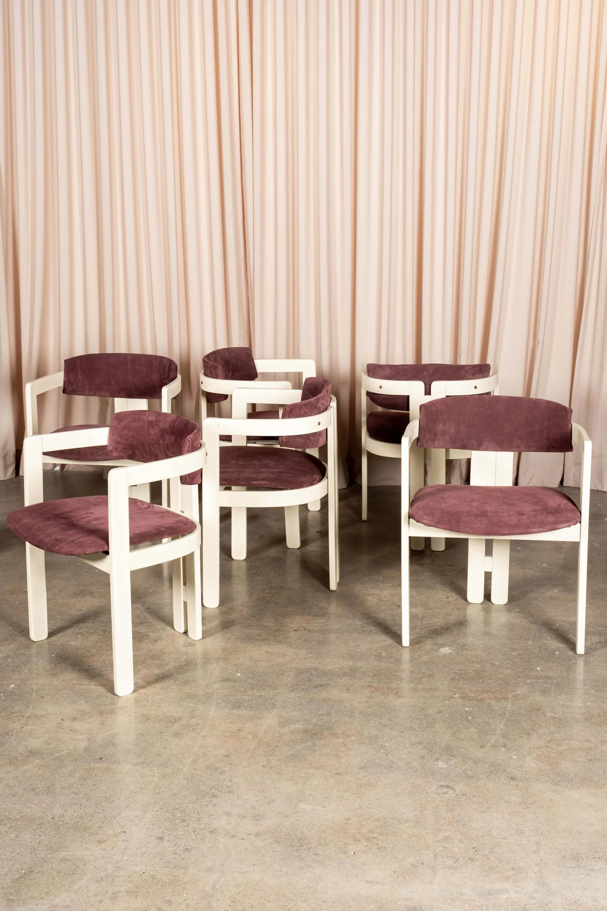 1960's dramatic white Italian armchairs with a just-right purple suede seat and back. The set of six chairs is sculptural and impactful, and manage to look great from every angle. In excellent condition for their age, the purple and white beauties