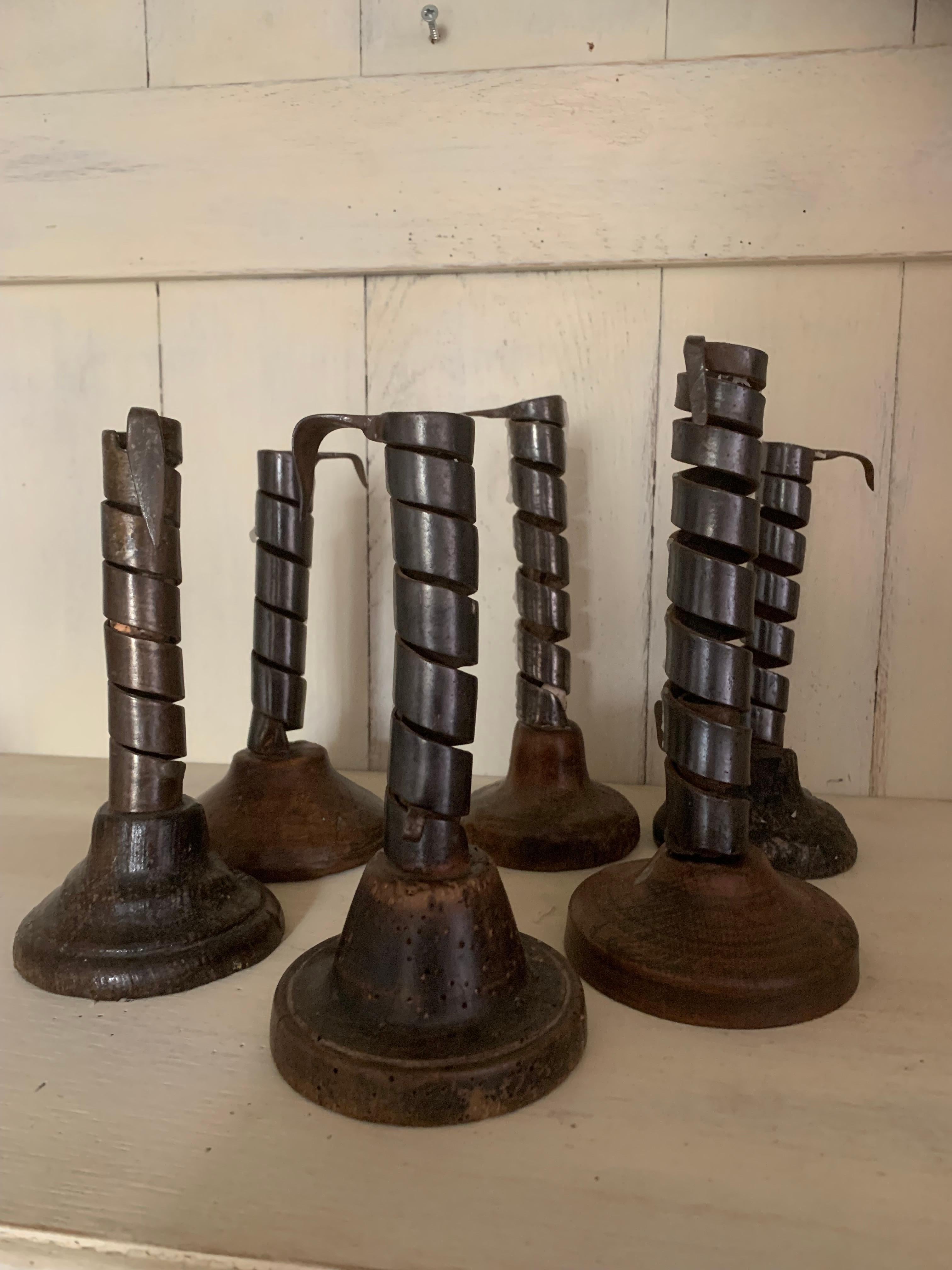 A set of 6 so called 'rat de cave' candlesticks. This type of candlestick holder was mainly used in France from the 17th to the 20th century. Rat de cave means as much as wine cellar dweller. They were hung (hence the hooks on top) throughout the