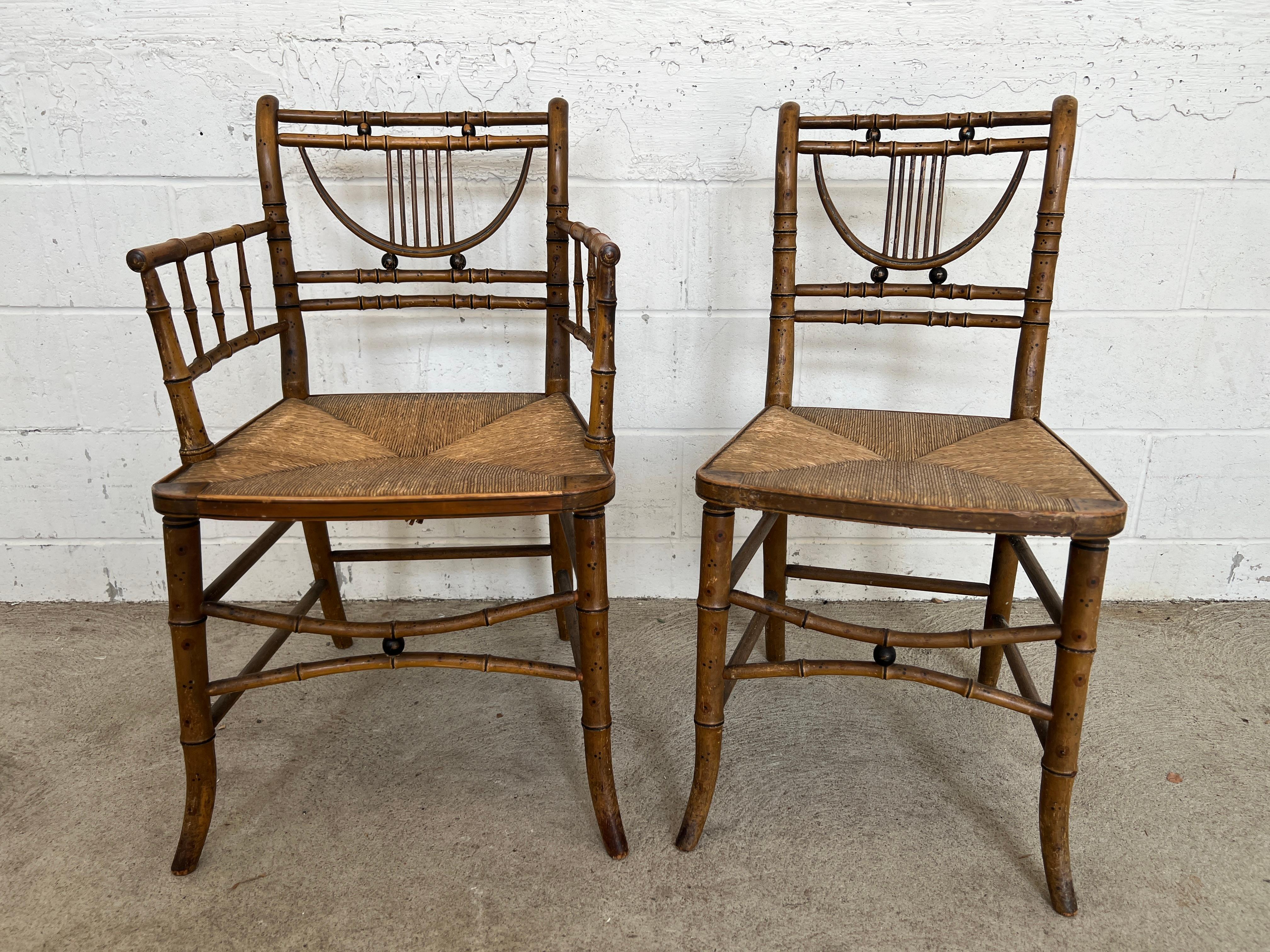 This set of six 19th-century simulated bamboo dining chairs is a rare and charming example of primitive furniture design, likely American in origin. Each chair features the original paint, beautifully worn to reveal its age and history. The