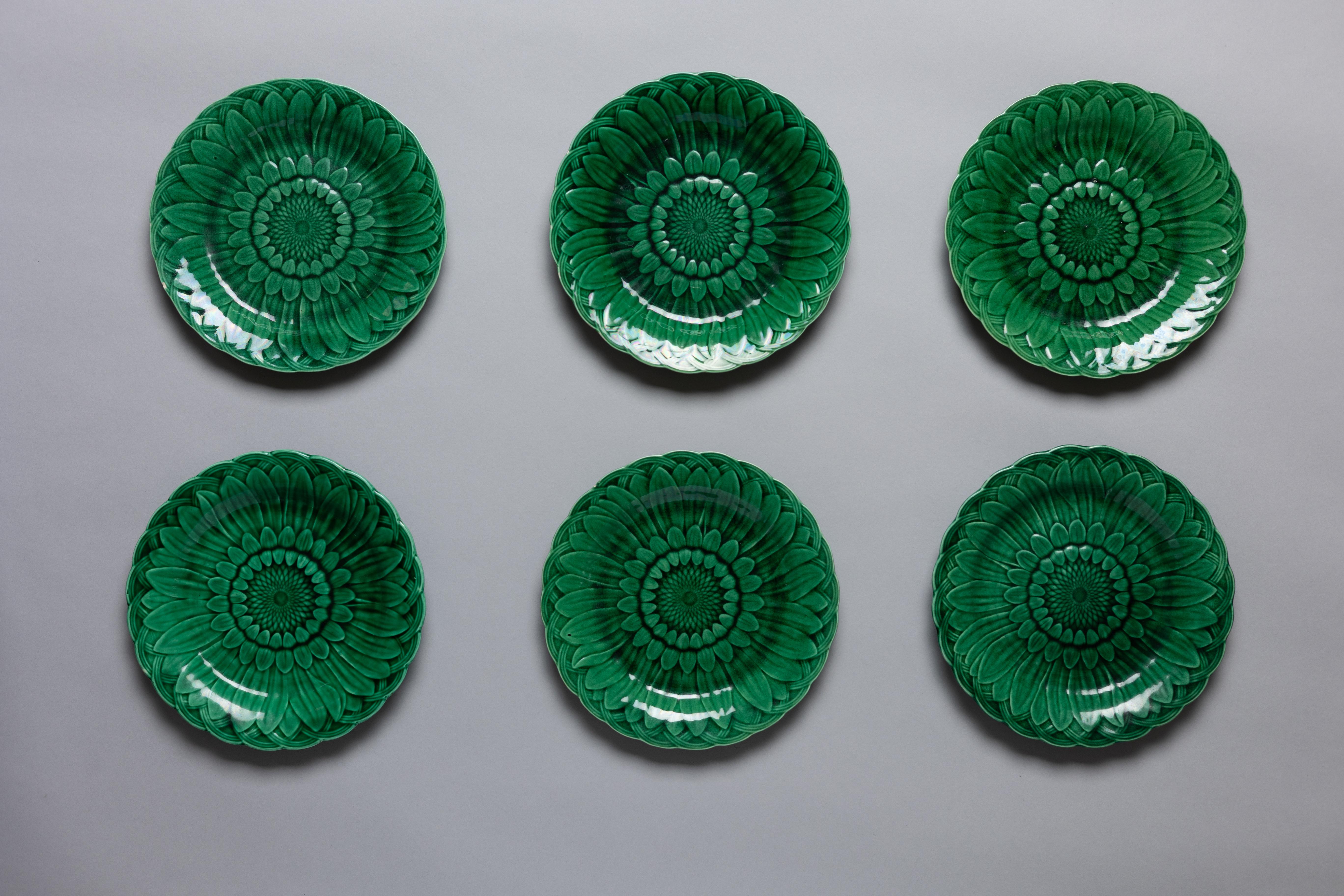 Set of 6 Aesthetic Movement green majolica glazed dinner plates in the ‘Sunflower’ pattern by Wedgwood, made circa 1880.

The sunflower, alongside the calla lily and peacock feather, became an emblem of the late nineteenth-century Aesthetic