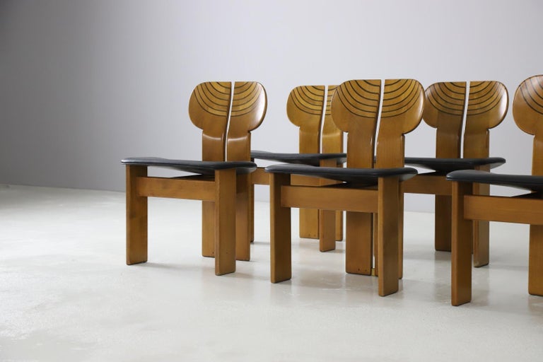 A fantastic and highly desirable set 'Africa' chairs designed by Afra & Tobia Scarpa. Produced by Maxalto, Italy 1975. Solid walnut bases with ebony inlays, brass details and smooth black leather upholstery. 
,