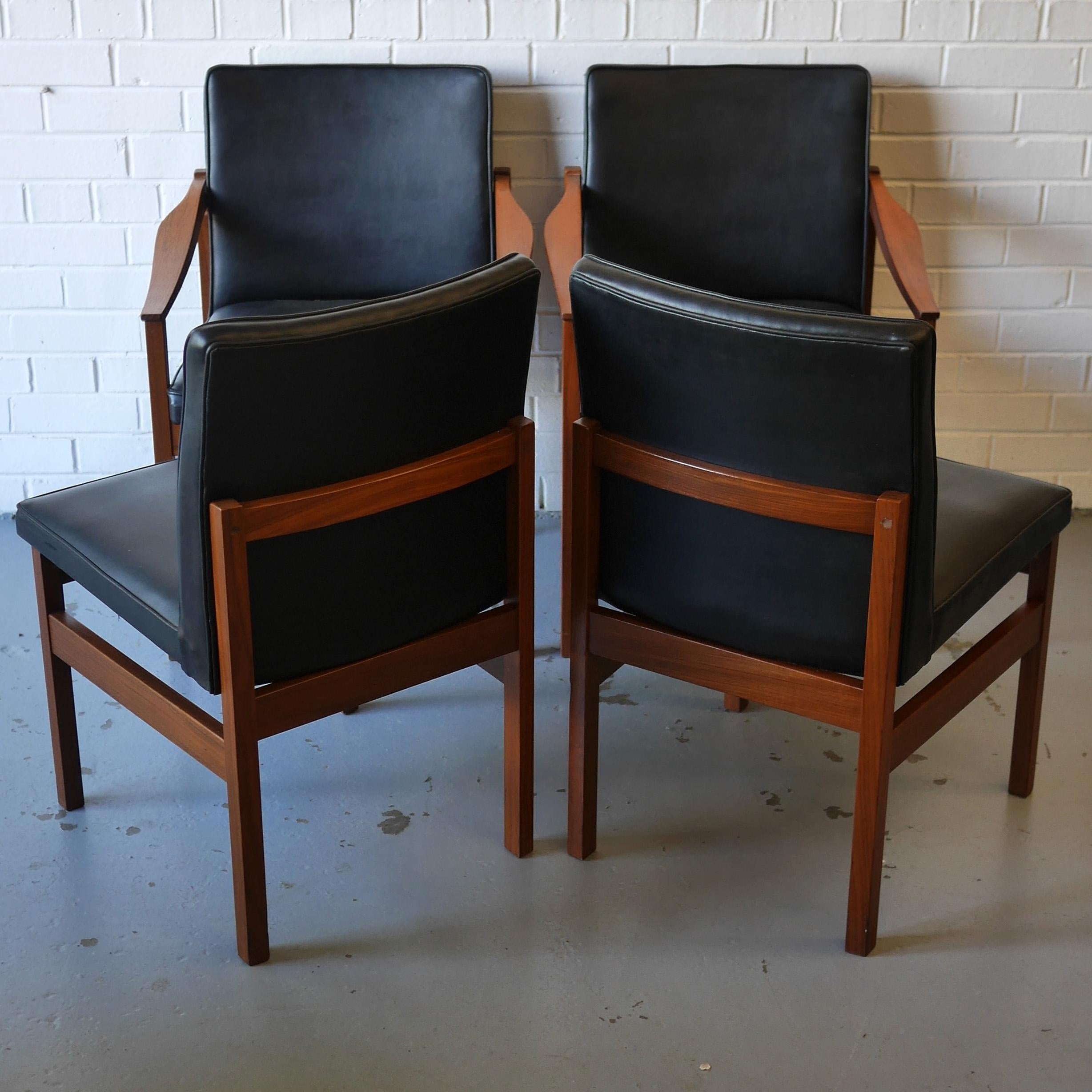 A set of 6 Knightsbridge solid afrormosia dining chairs with black vinyl seats - 2 carvers and 4 standard chairs with square cut angular frames and a generous seat base and back designed by Robert Heritage for Archie Shine. In good 'as found'