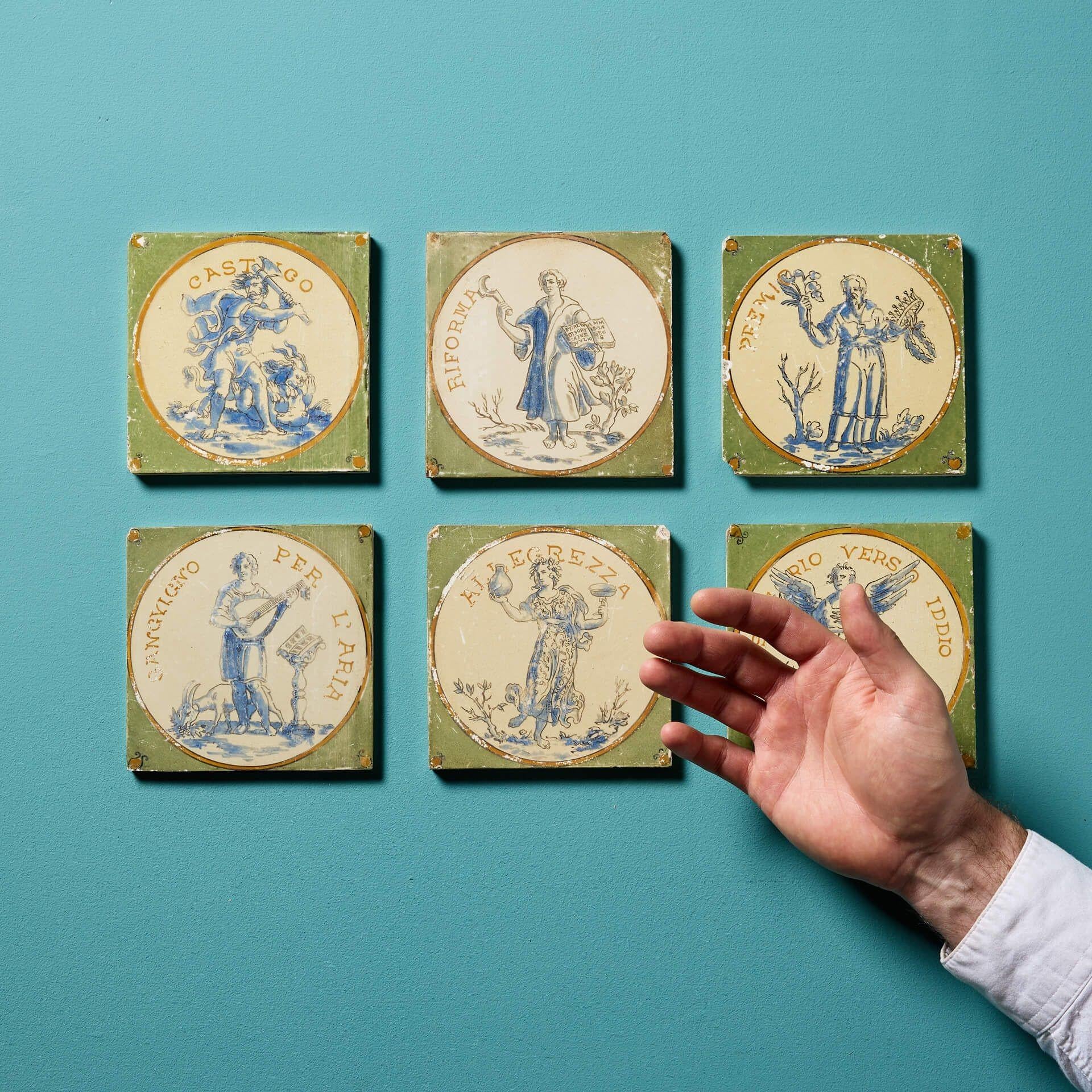 A set of six early 19th century tiles decorated Barrowclough & Sanders on a Minton tile.

In Neoclassical style, each 5 inch tile showcases classically dressed figures, musicians, and warriors hand painted in tonal blue with ochre coloured ornaments