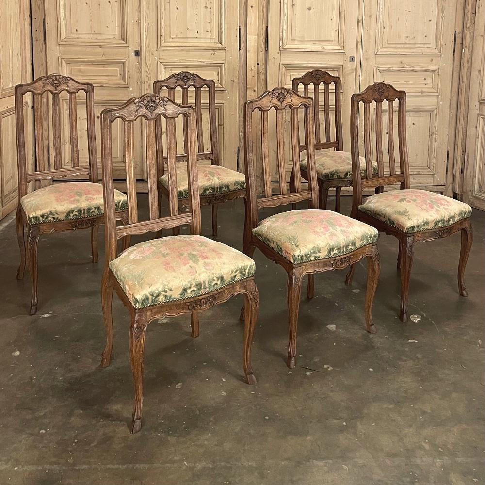 Set of 6 antique country French dining chairs feature contoured seatbacks with three slats for extra comfort while providing light weight making them easy to move about the dining room. Each arched seatback crown has been carved by hand with shell