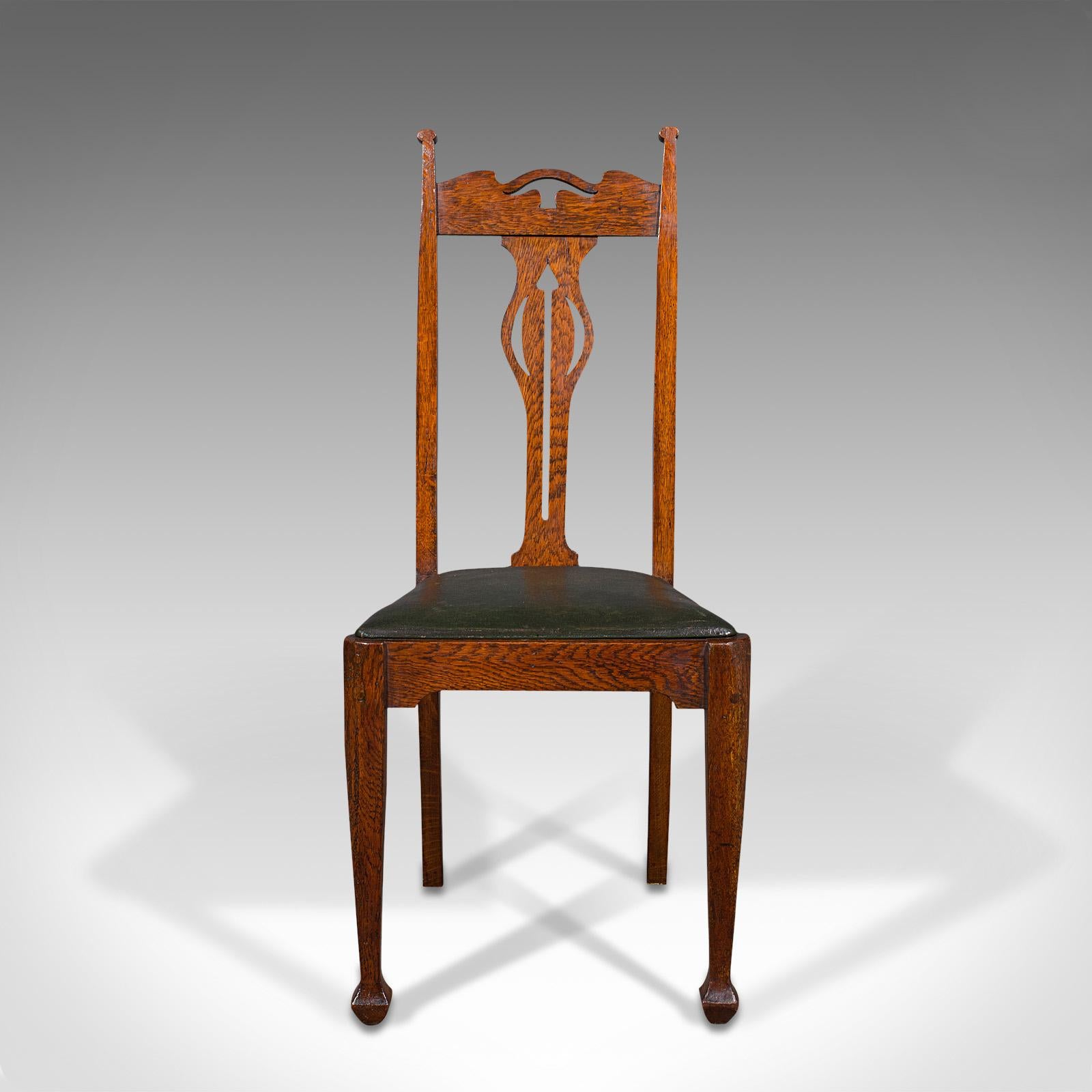 This is a set of 6 antique dining chairs. An English, oak seat in the manner of Liberty, dating to the late Victorian period, circa 1900.

Dashing colour, figuring and finish sets apart this dining suite
Displaying a desirable aged patina