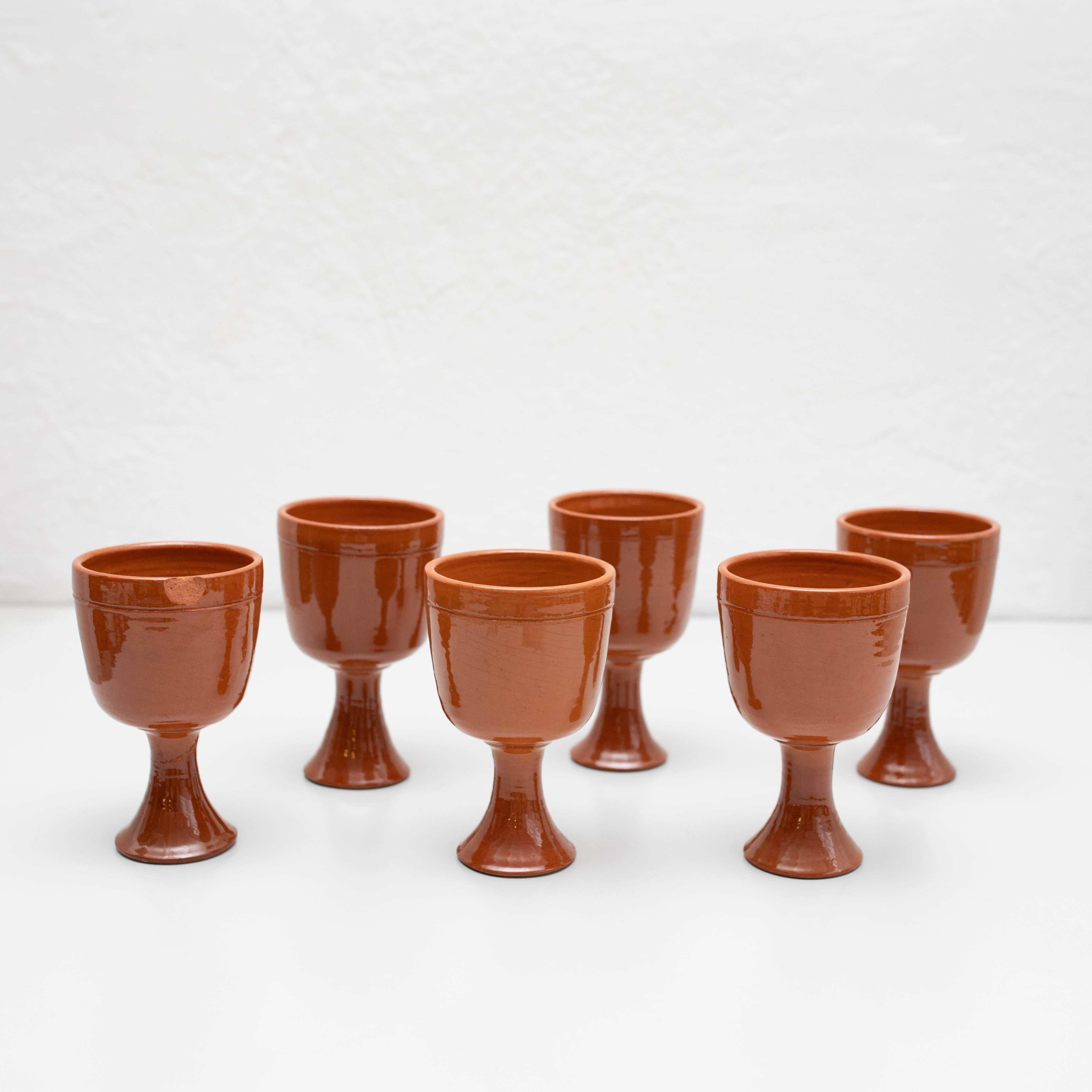 Set of 6 Antique Earthenware Wine Cups,    Made by unknown manufacturer in Spain, circa 1950.    In original condition, with minor wear consistent with age and use, preserving a beautiful patina. Some has cracks.    Materials:  Earthenware   