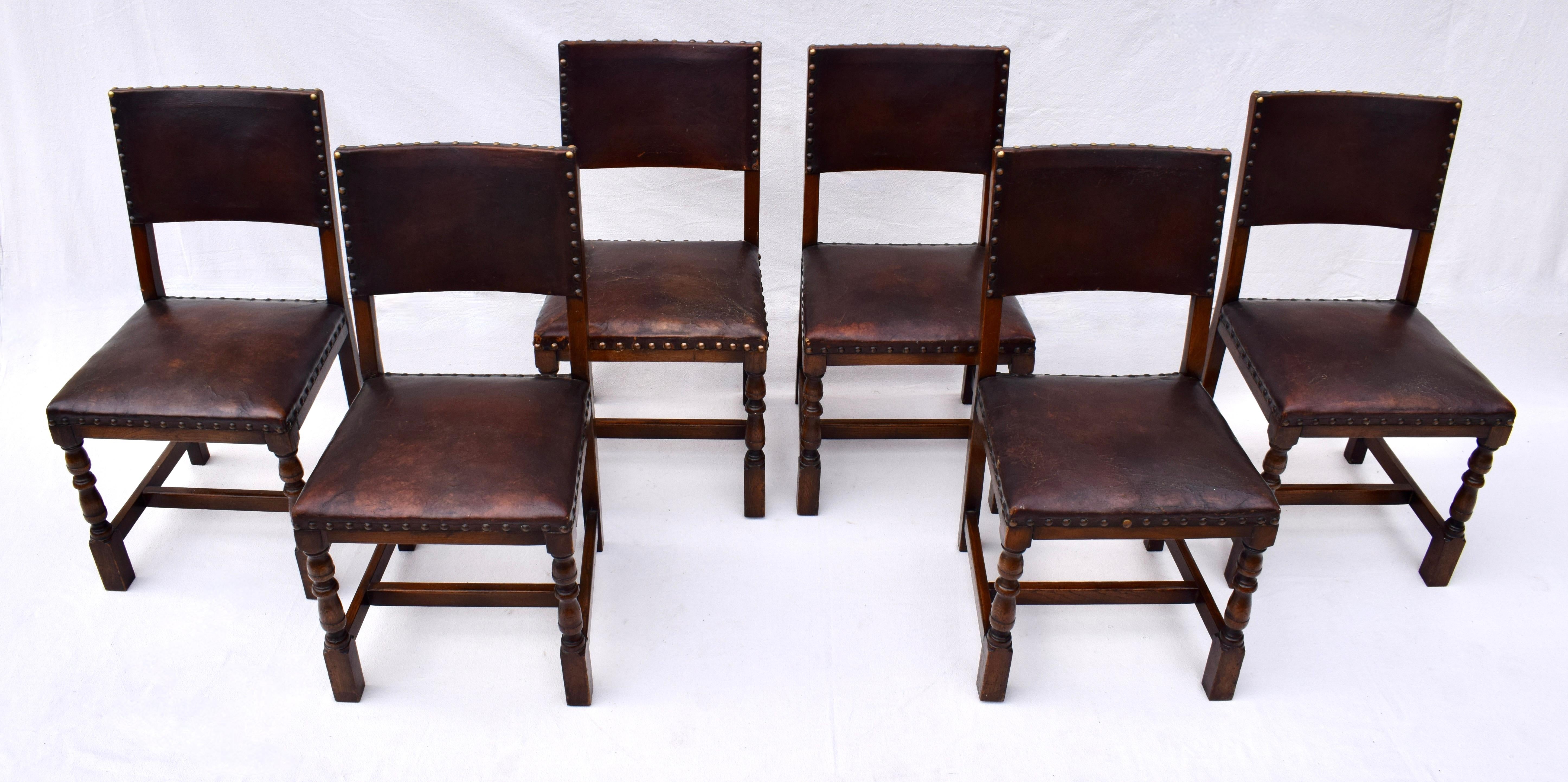 Set of 6 antique English Oak and leather chairs with brass tack fittings.  Well made and comfortable the leather upholstery is original, nicely distressed in places but still solid and sound.  Hand detailed with fully reinforced seats & joinery