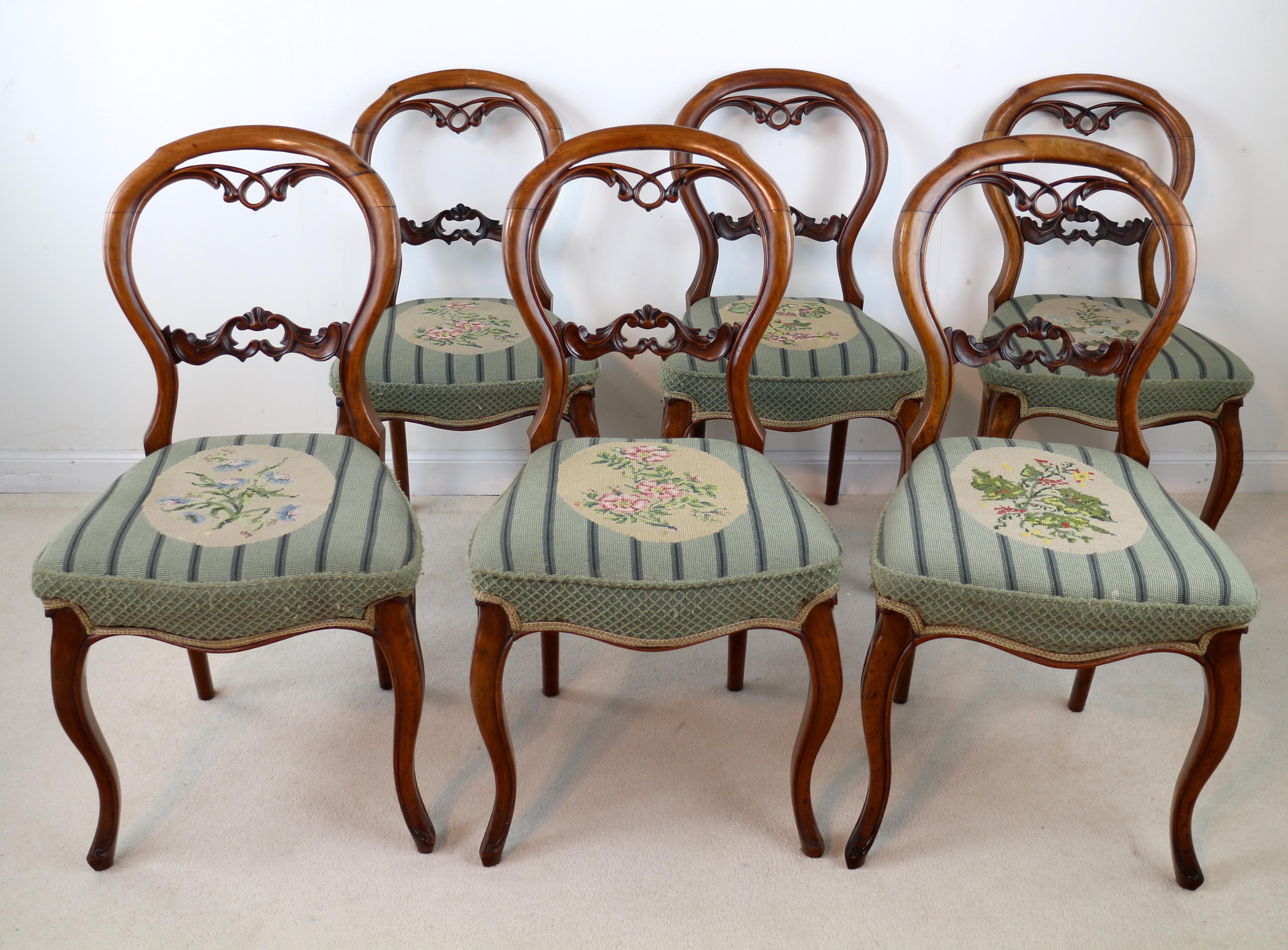 A super original set of six Victorian walnut balloon back dining chairs dating to around 1860. With decorative pierced and carved backs above gros-point floral needlework seats and on cabriole legs. These are good examples of this attractive style