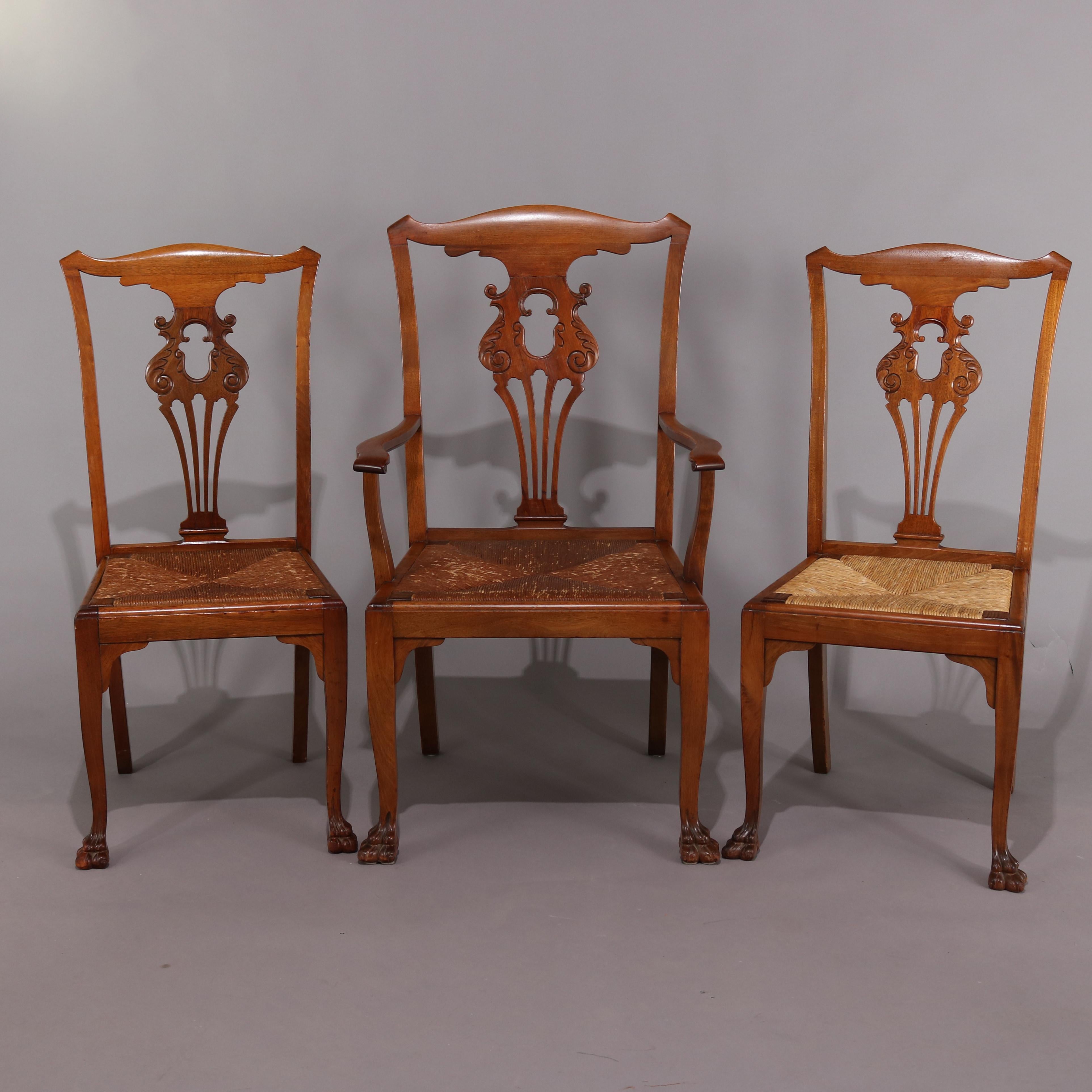 Set of 6 antique French Louis XIV style mahogany dining chairs feature pieced backs with foliate design, rush seats, and includes one arm chair and five side chairs, circa 1920

Measures: armchair 42.25