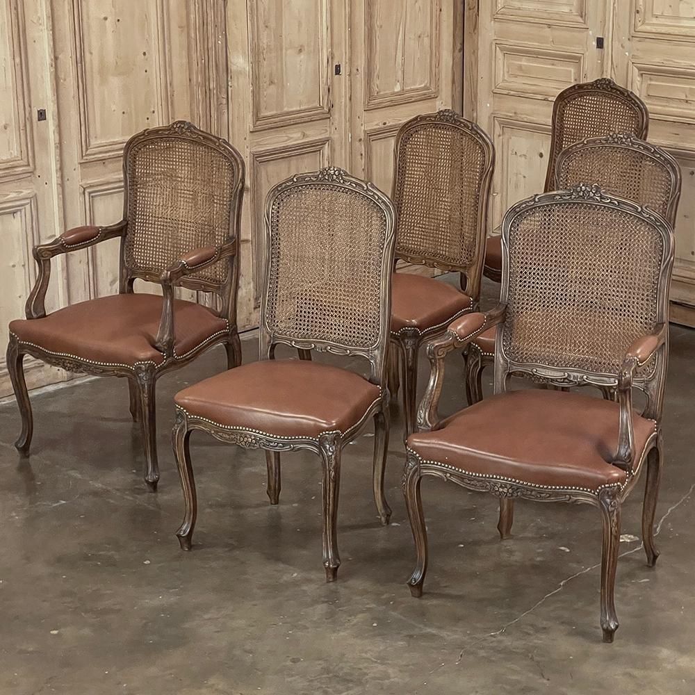 Set of 6 Antique French Louis XV Fruitwood Dining Chairs includes 2 Armchairs exude all the elegance of the style, but in a subtle and sophisticated expression.  Hand-crafted and artfully carved from solid fruitwood, the set features a gentle arch
