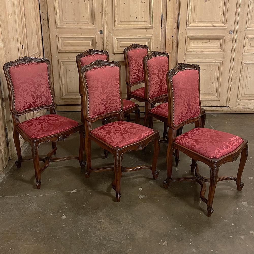 Set of 6 Antique French Louis XV walnut dining chairs with silk damask were sculpted from select French walnut with the naturalistic form that is a hallmark of the style. Hourglass shaped seatbacks feature elegant molded detail all around, with