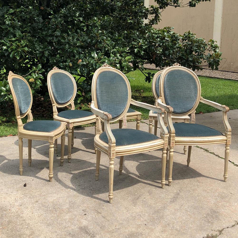 Set of 6 antique French Louis XVI painted dining chairs includes 2 armchairs! Add classical elegance to your dining experience, but with a toned down formality that works with more casual decors. Contoured oval seatbacks and generously sized seats