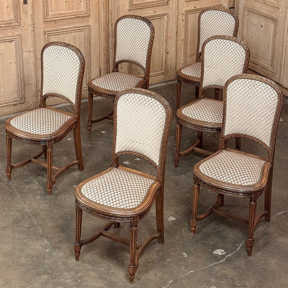 Set of 6 Antique French Louis XVI Upholstered Dining Chairs were hand-crafted from fine walnut and recently upholstered making them ready to make your dining experience as comfortable as it is elegant!  Subtly arched seat backs and lyre-shaped seat