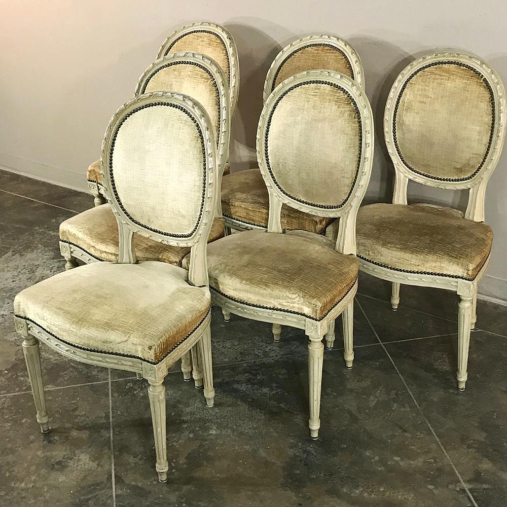 Set of 6 antique painted Louis XVI chairs feature a well-cushioned design upholstered in mohair, with contoured oval seatbacks for fine comfort while dining! spiral ribbon, acanthus rosettes, and tapered and fluted legs adorn the framework, which