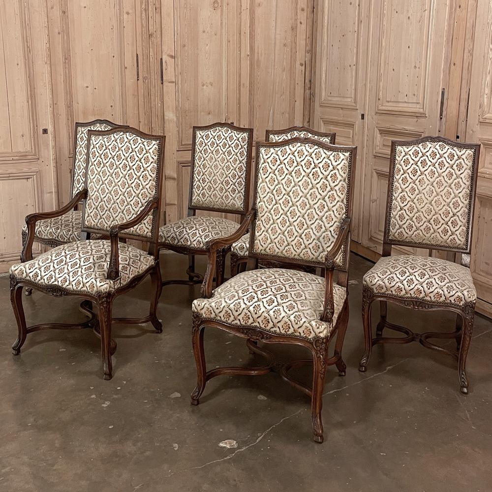 Set of 6 Antique French Regence dining chairs includes 2 armchairs and represent the perfect combination of form, function and comfort! Gracefully arched seatbacks are generously sized, as are the seats, and all upholstered in fine, luxurious
