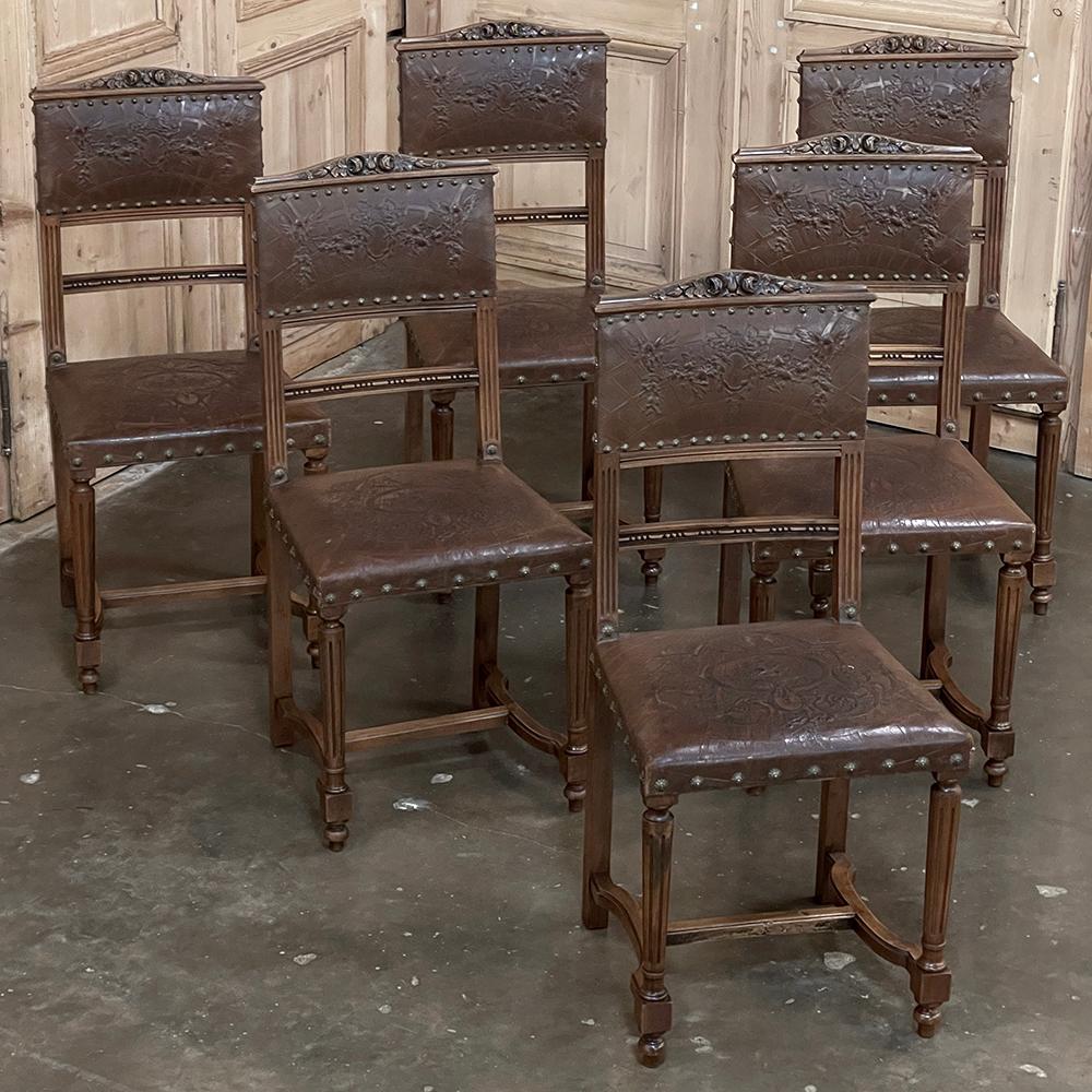 Set of 6 Antique French Walnut Louis XVI Dining Chairs with Embossed Leather will make an excellent addition to your dining experience!  The neoclassical architecture is immediately apparent, with tapered and fluted front legs and fluting on the