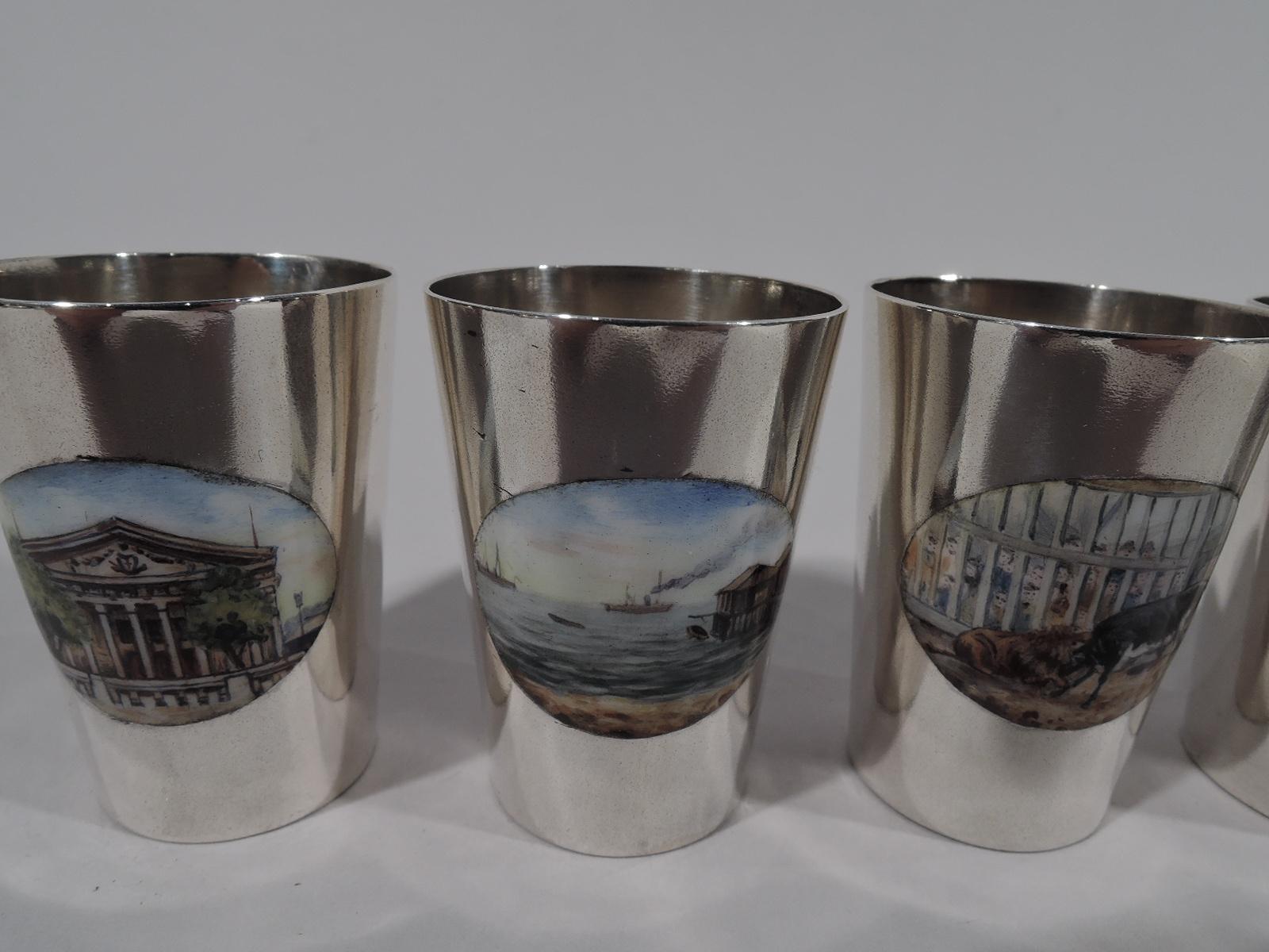 Six German 900 silver shot glasses, ca 1920. Each: Straight and tapering sides and oval enamel medallion depicting historic buildings, navigation, and the wonders of nature. A fun set for the lockdown-era armchair traveler. Marked. Total weight: 5