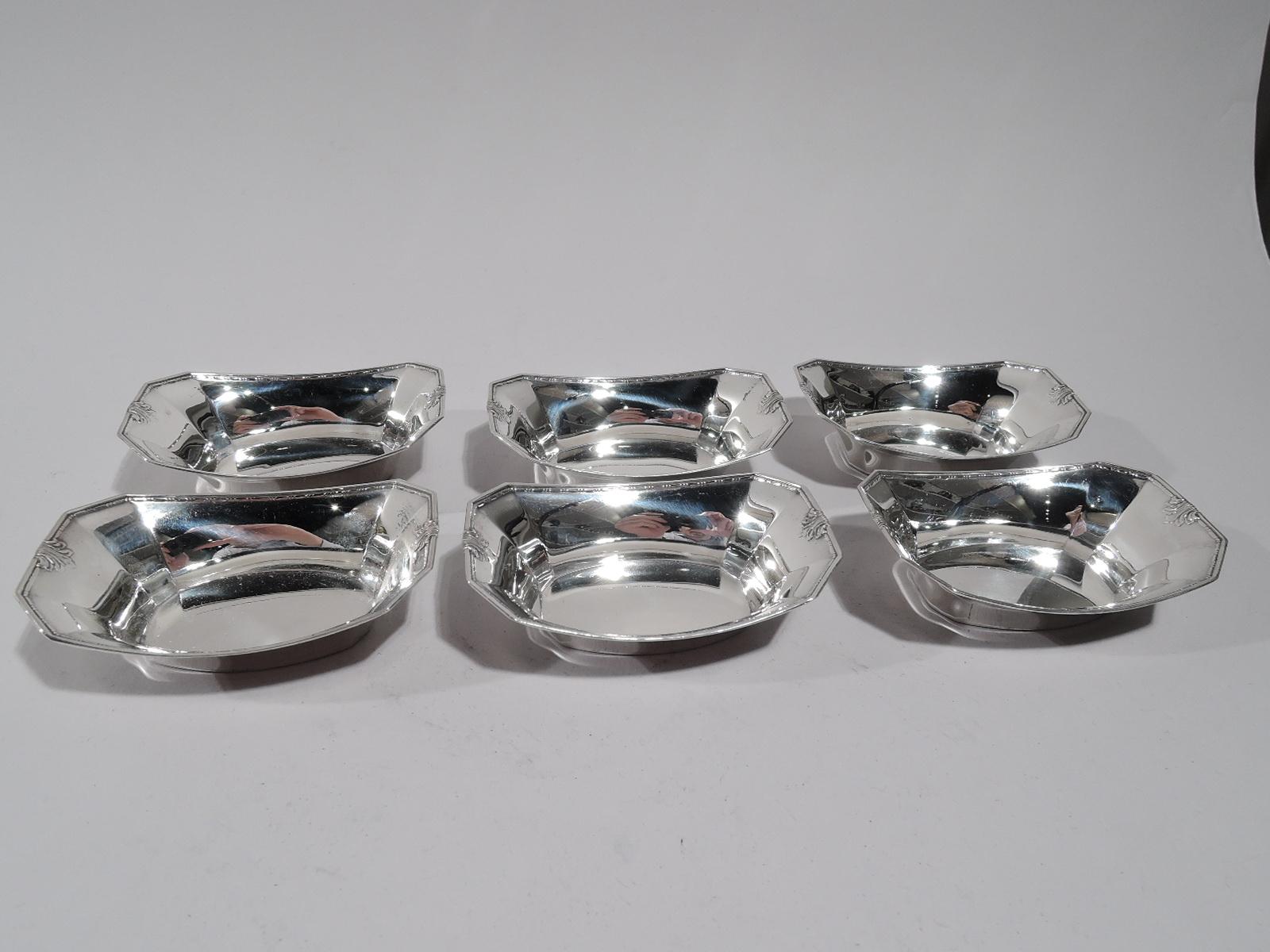 Set of 6 Edwardian sterling silver nut dishes. Made by Gorham in Providence in 1931. Ovalish well with tapering sides and chamfered corners. Chased bead-and-reel rim and leaves at ends. Fully marked including no. 1065 and date symbol. Total weight: