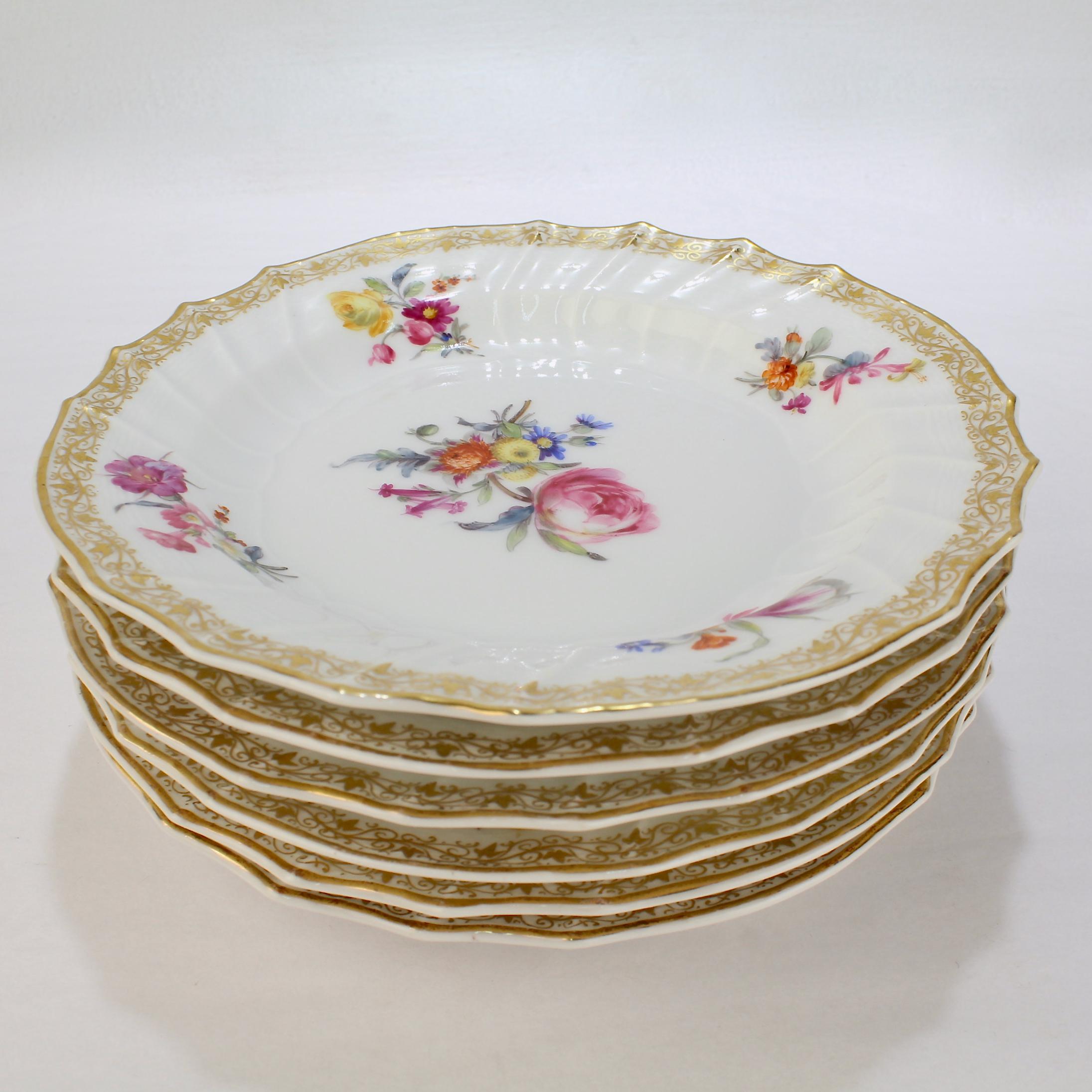 A fine set of 6 Neuosier pattern antique porcelain cake plates.

By KPM (Königliche Porzellan-Manufaktur)

With Deutsche Blumen decor to the center, floral sprays to the edge, and rich gilding to the rim. 

Several plates have tiny insects and