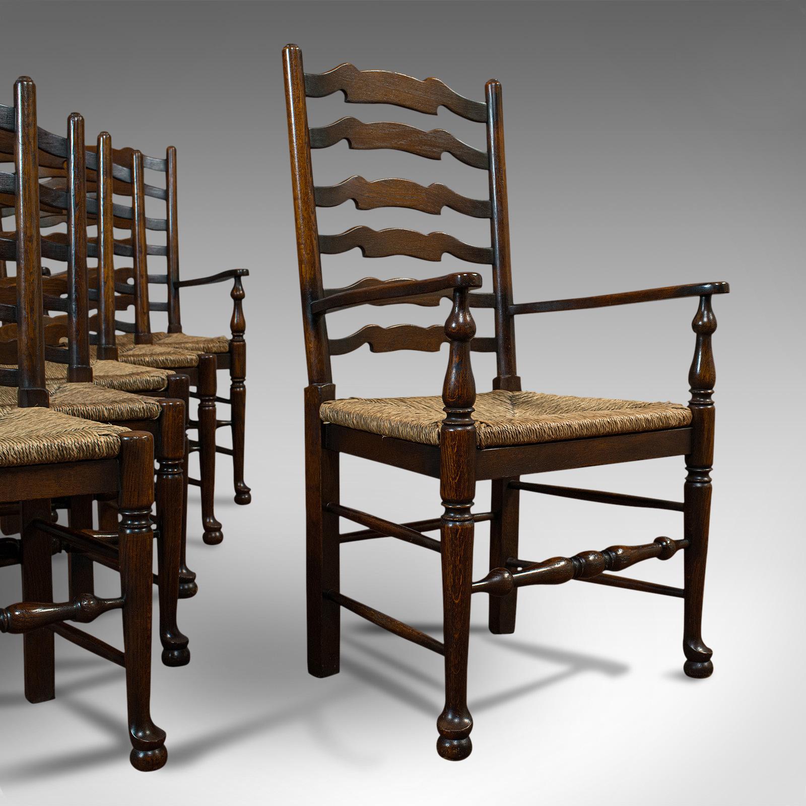 This is a set of six antique ladderback dining chairs. An English, oak rush seat set with pair of carver elbow chairs, dating to the Edwardian period, circa 1910.

Set has four standards and a pair of carver elbow chairs
Good quality in English