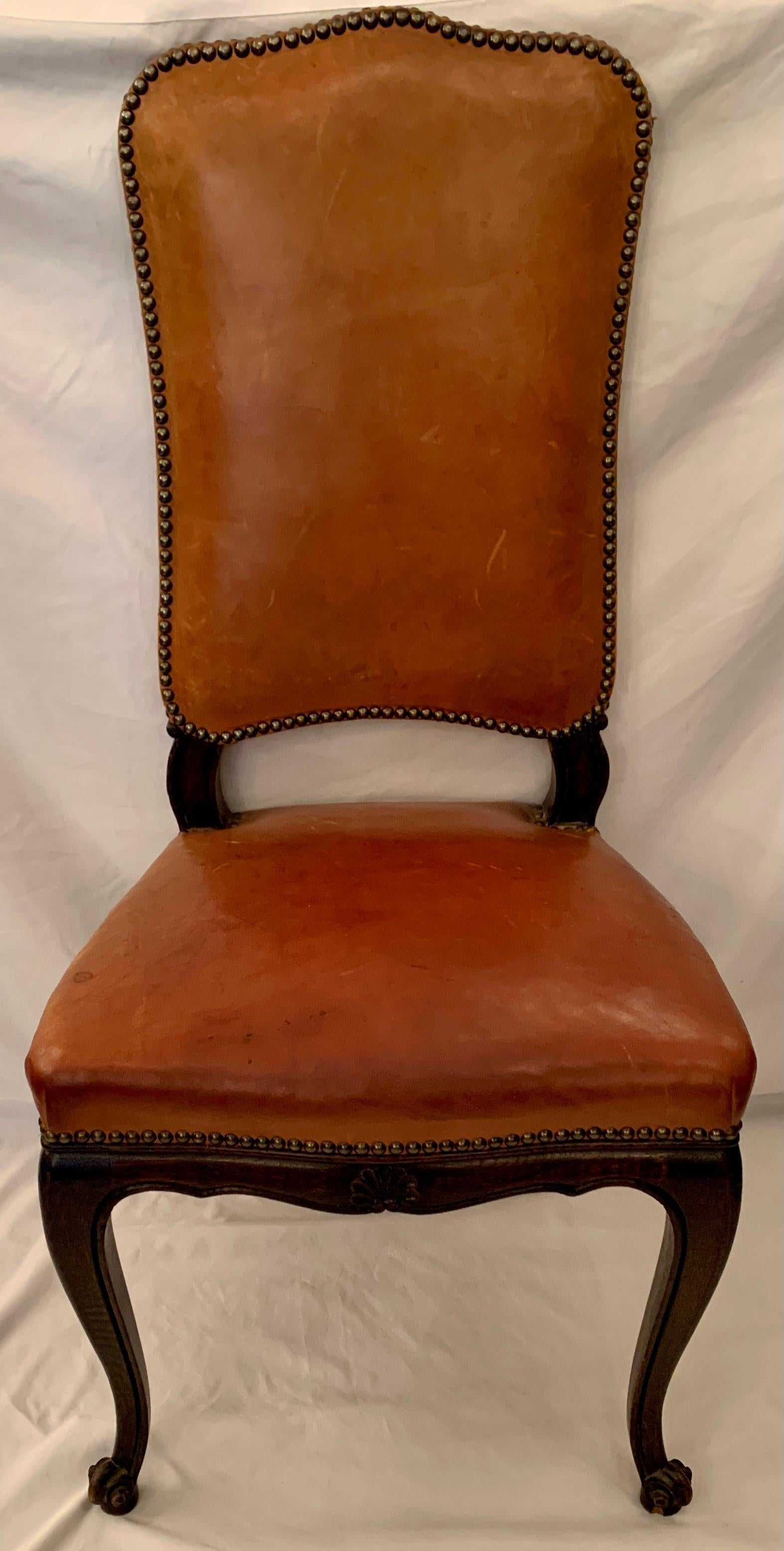 Set of 6 antique leather dining chairs with grommets, Circa 1890-1910.
