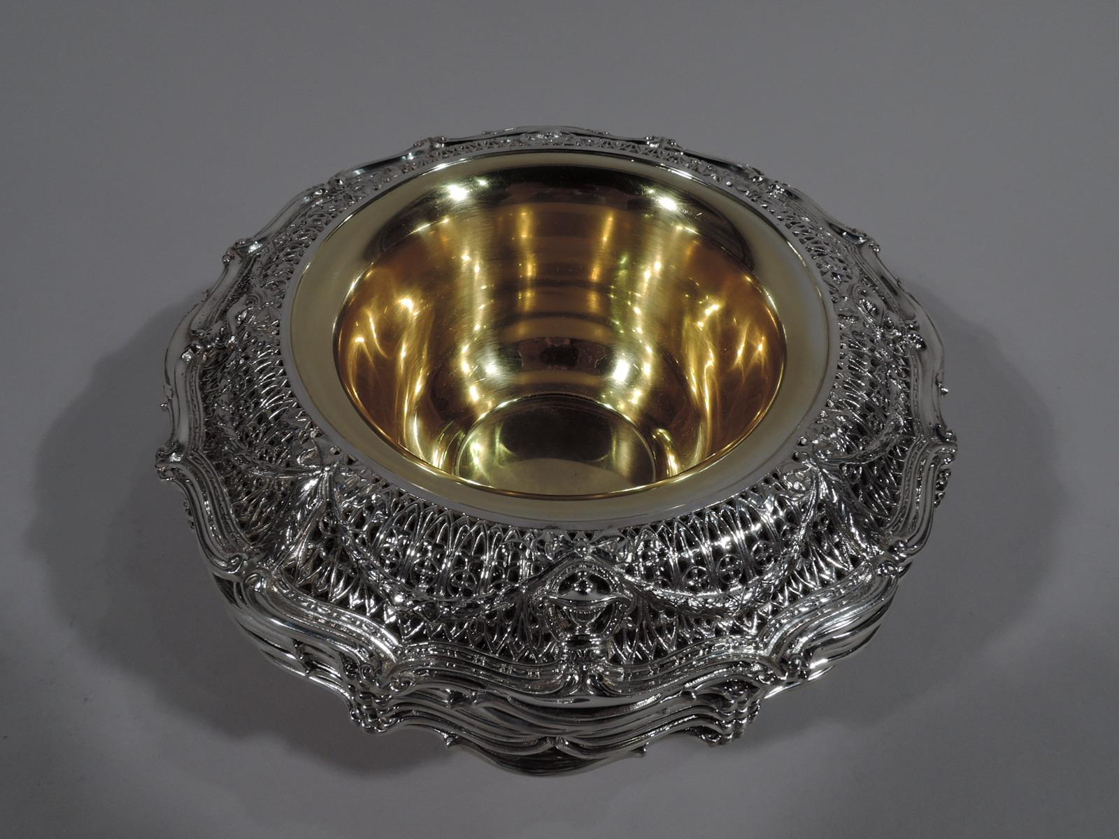 Set of 6 Edwardian Regency sterling silver dessert bowls in Adam pattern. Made by Shreve & Co. in San Francisco, circa 1915. Deep, tapering, and gilt well. Wide and turned-down shoulder with Classical vases on open rondels joined by leaf swag on