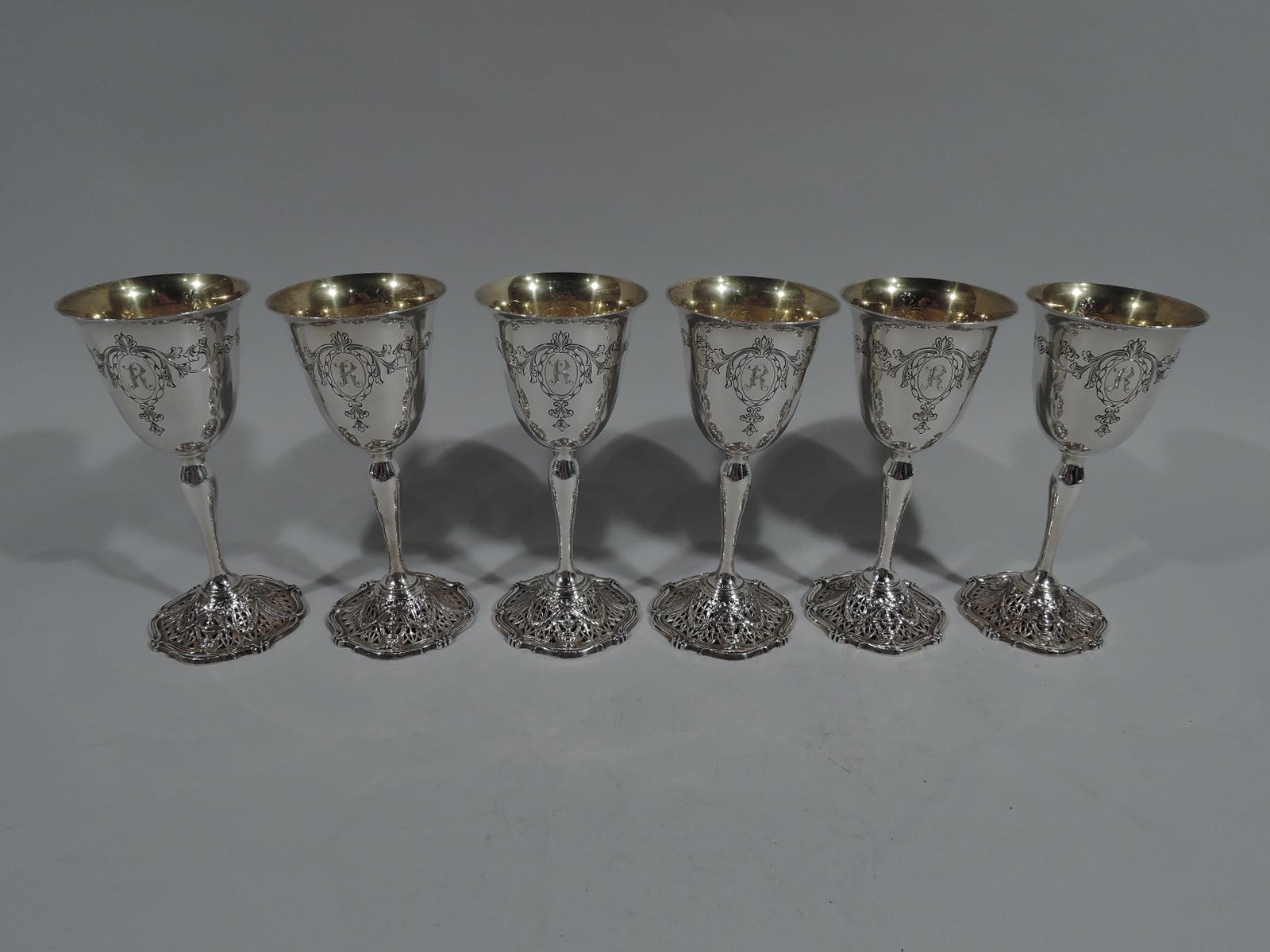 Set of 6 Edwardian Regency sterling silver goblets in Adam pattern. Made by Shreve & Co. in San Francisco, circa 1915. Each: Bell-form bowl, baluster stem, and domed foot. Bowl exterior has two engraved oval frames with leafy scrolls and pendant